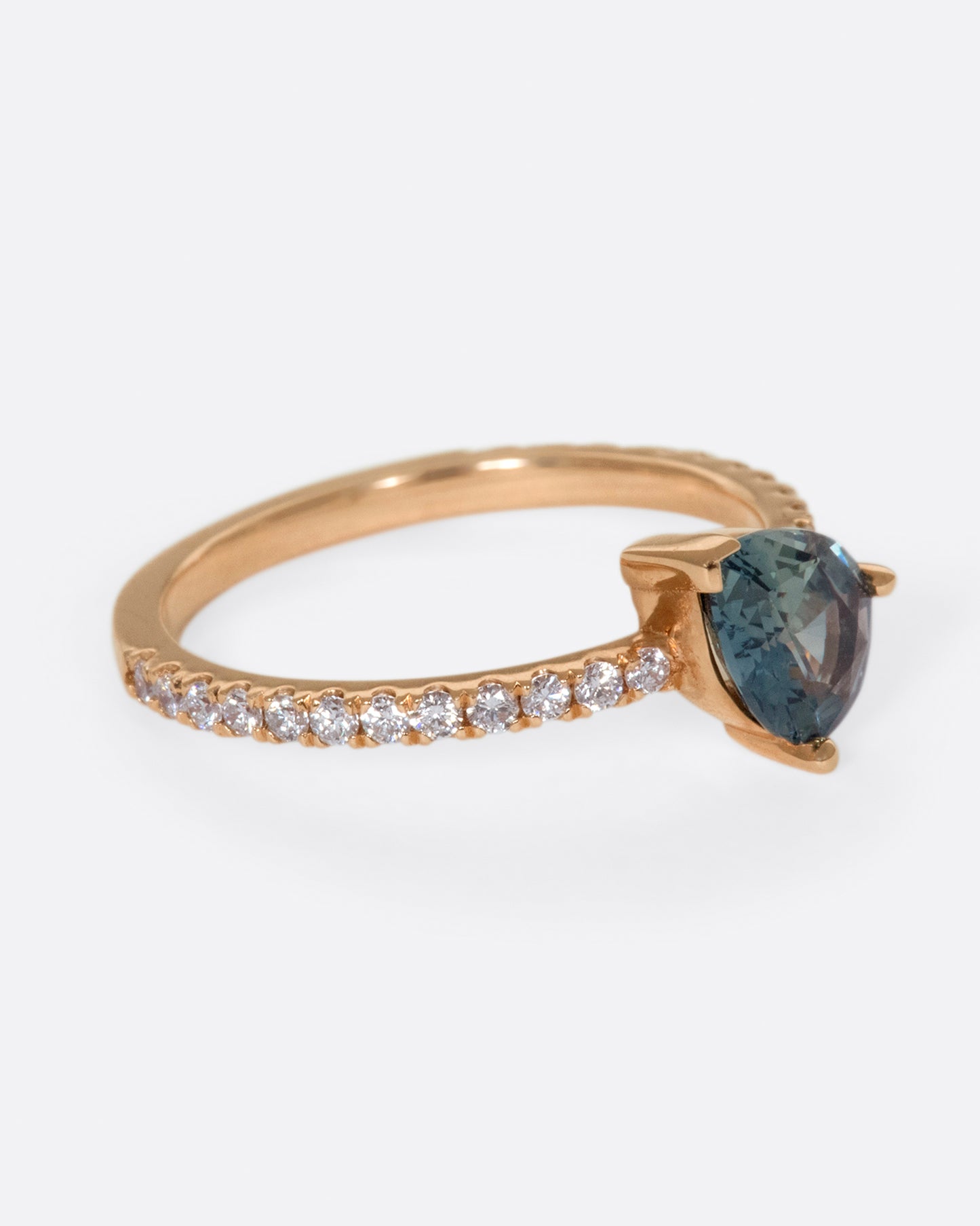 The saturated blue-green sapphire is the star of this ring.