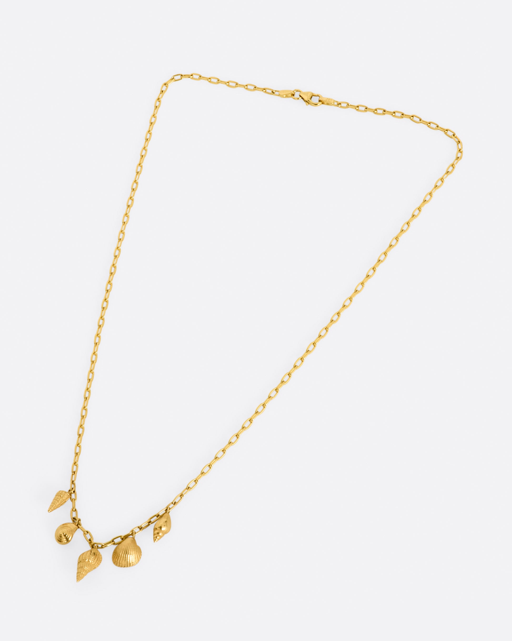 A yellow gold oval link chain necklace with five 3D shell charms in various styles.