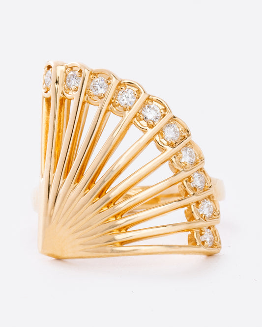 This incredible ring, modeled after the shape of a fan, features brilliant cut diamonds along its edge.