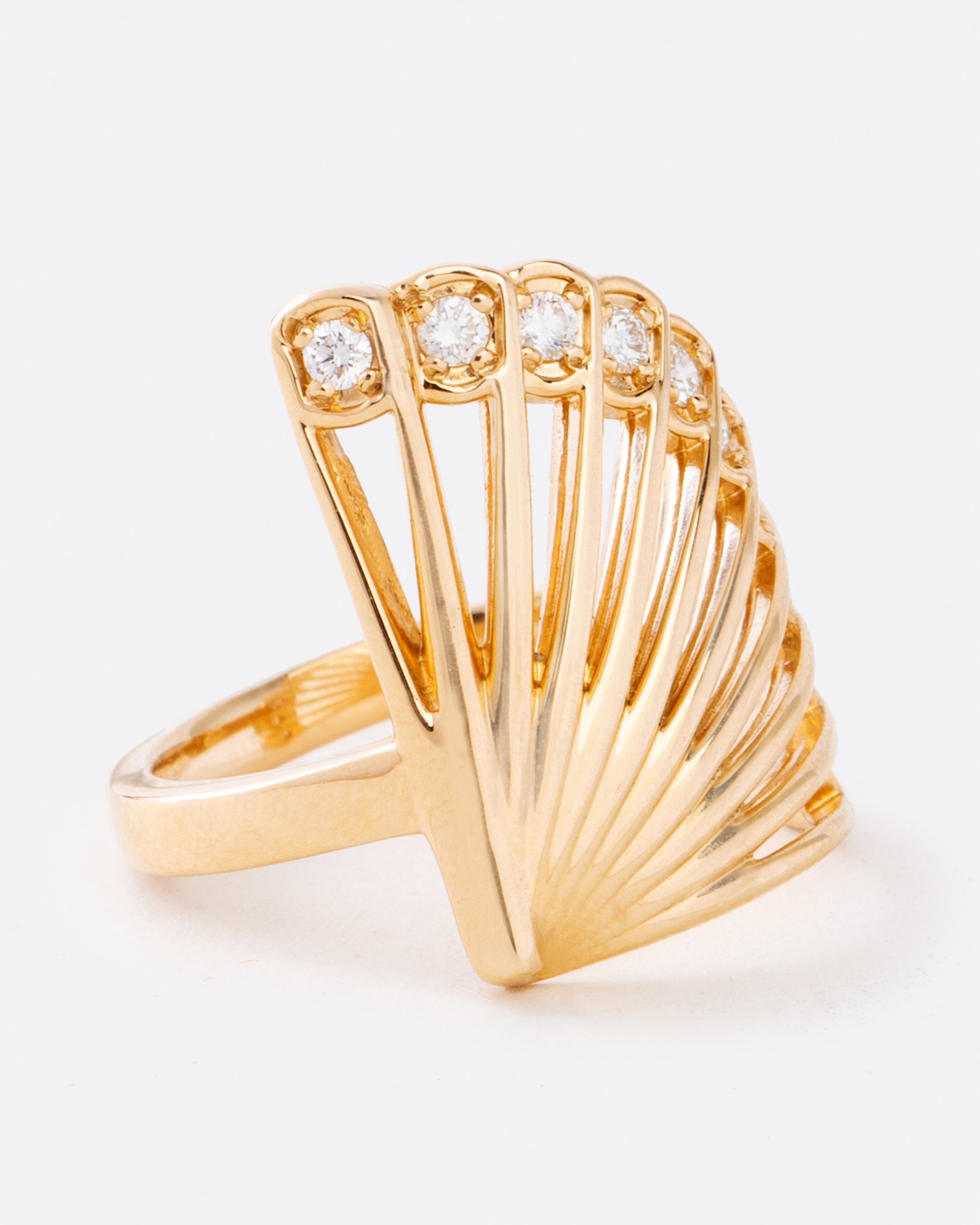 This incredible ring, modeled after the shape of a fan, features brilliant cut diamonds along its edge.