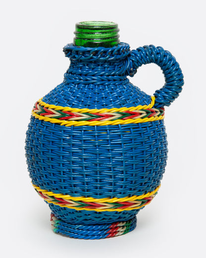 A glass Hungarian Miner's Bottle with a colorful pattern of woven electrical wire on top, shown from the side.