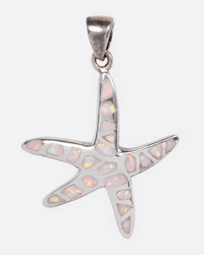 A silver starfish pendant with opal inlay show from the front.