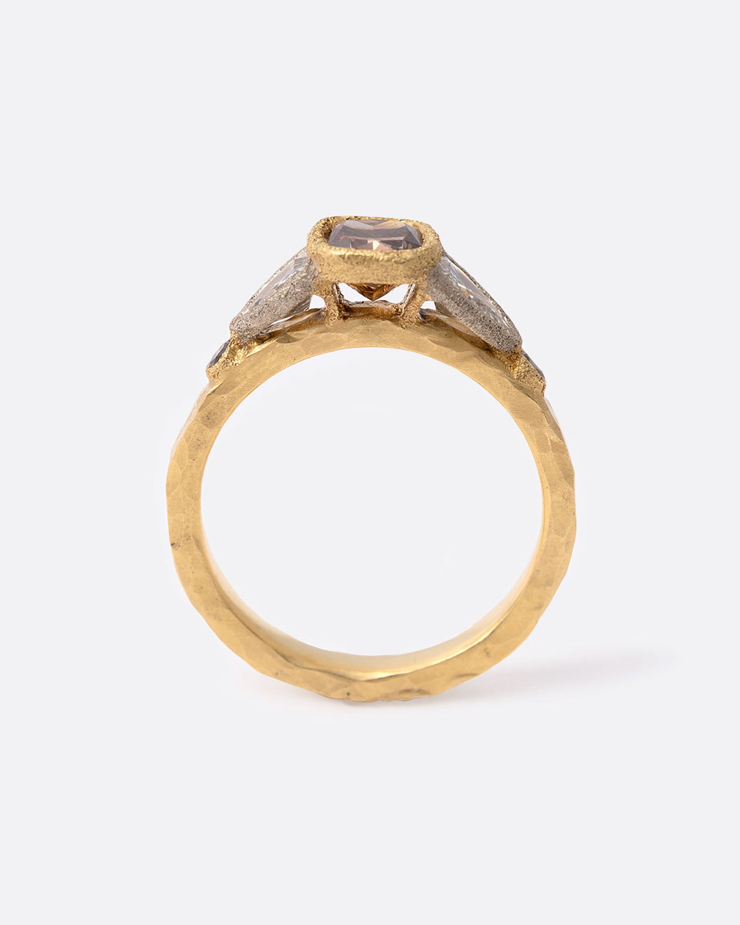 18k yellow gold ring with cushion cut brown diamond, two shield shaped white diamonds, and two round brown diamonds by Todd Pownell, shown from the side.