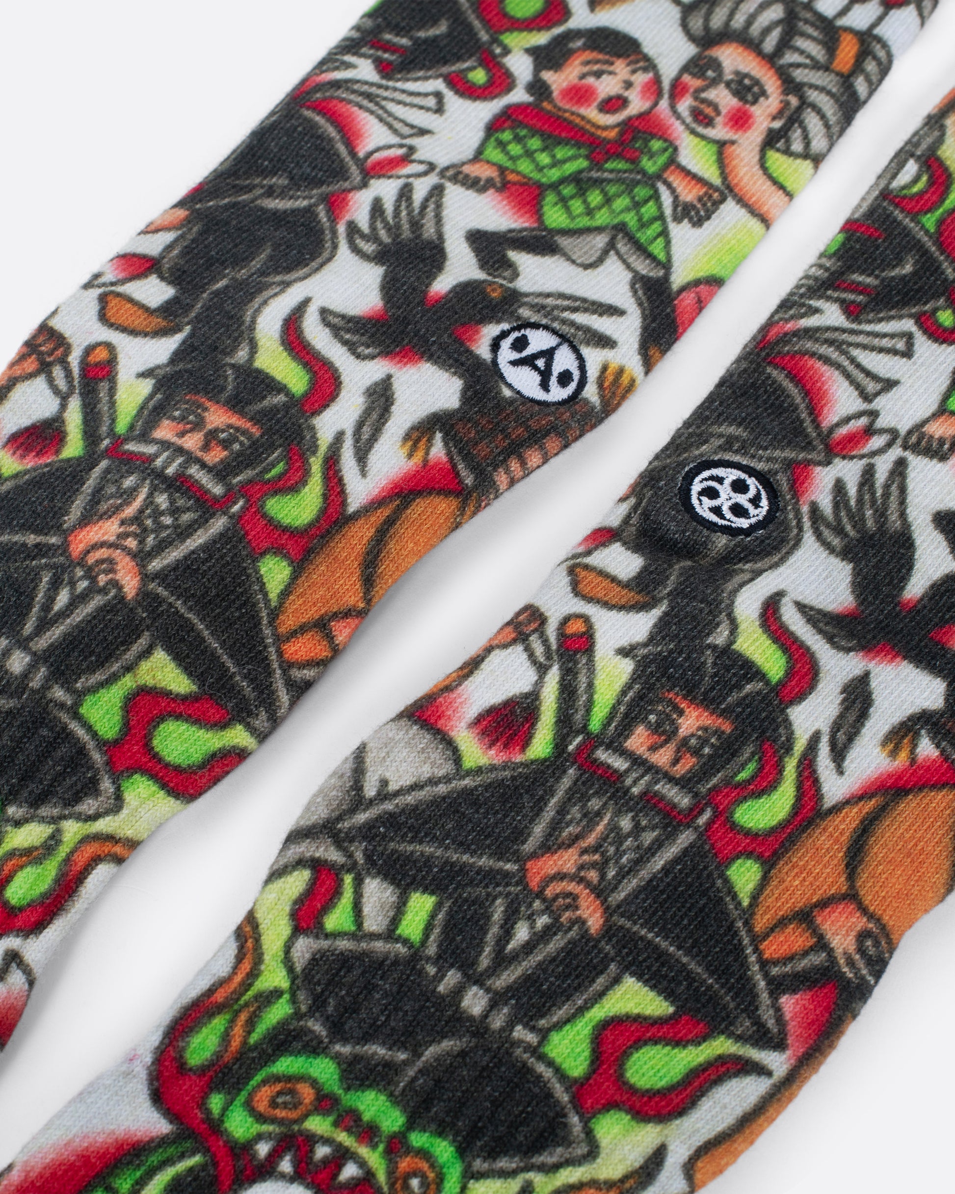 Socks with traditional Japanese style scene of people, ninjas and frogs. Close up view.