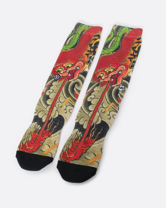 Socks with dragon spitting fire surrounded by smoke clouds. View from the front.