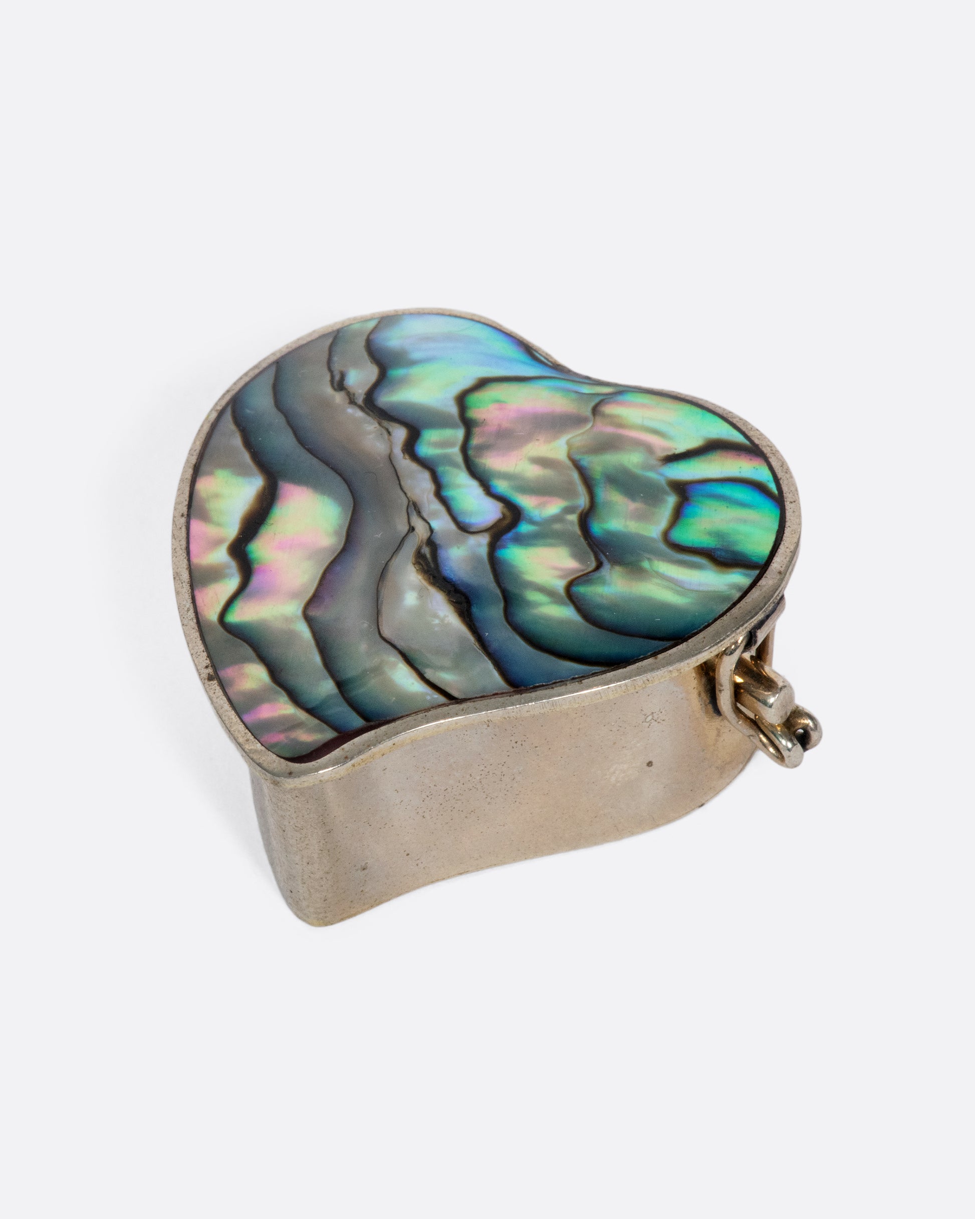 The heart-shaped abalone shell inlaid in this beautiful vintage box always makes us smile and think of the beach.