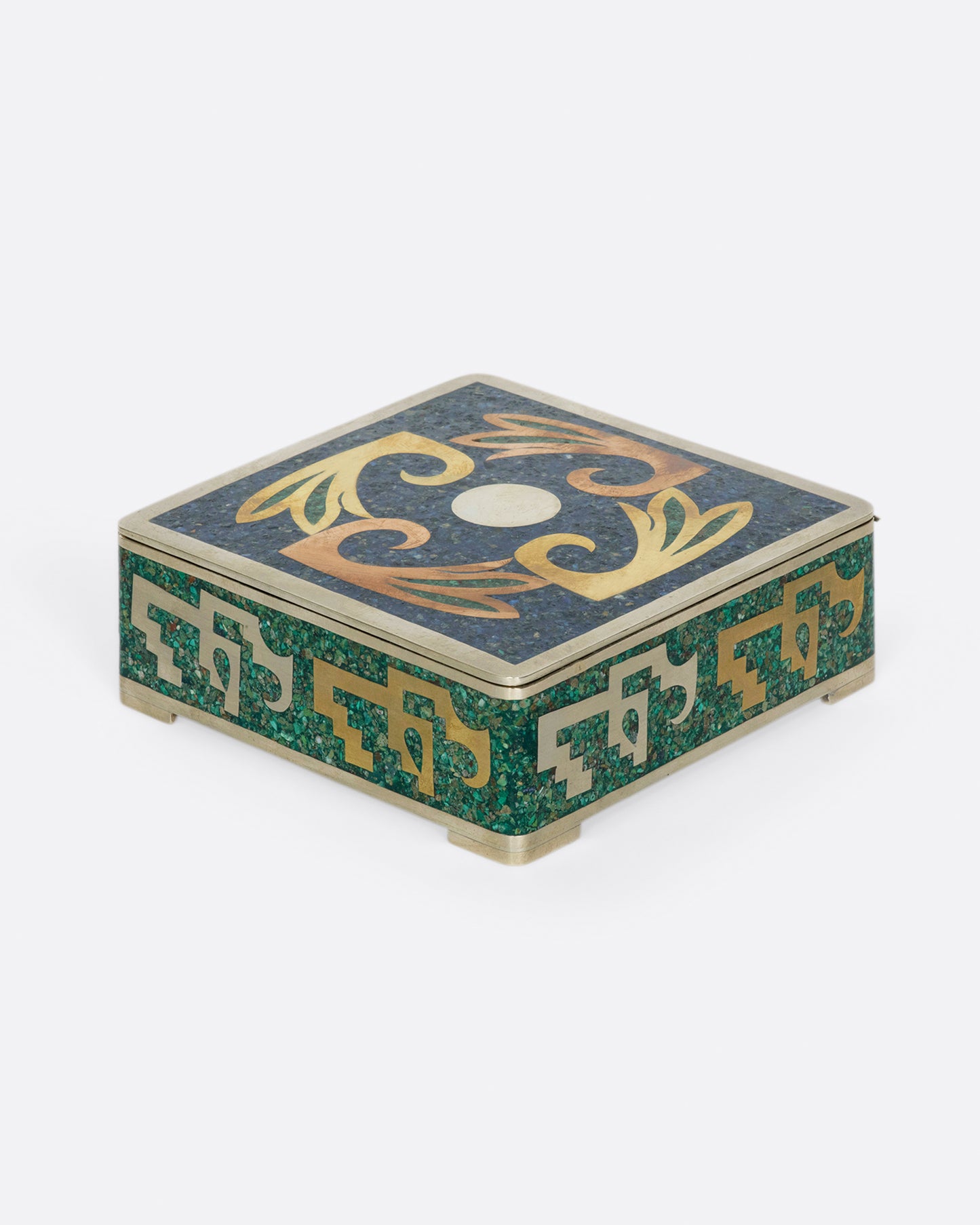 A Mexican, hinged box covered in sodalite malachite inlay and lined with wood.