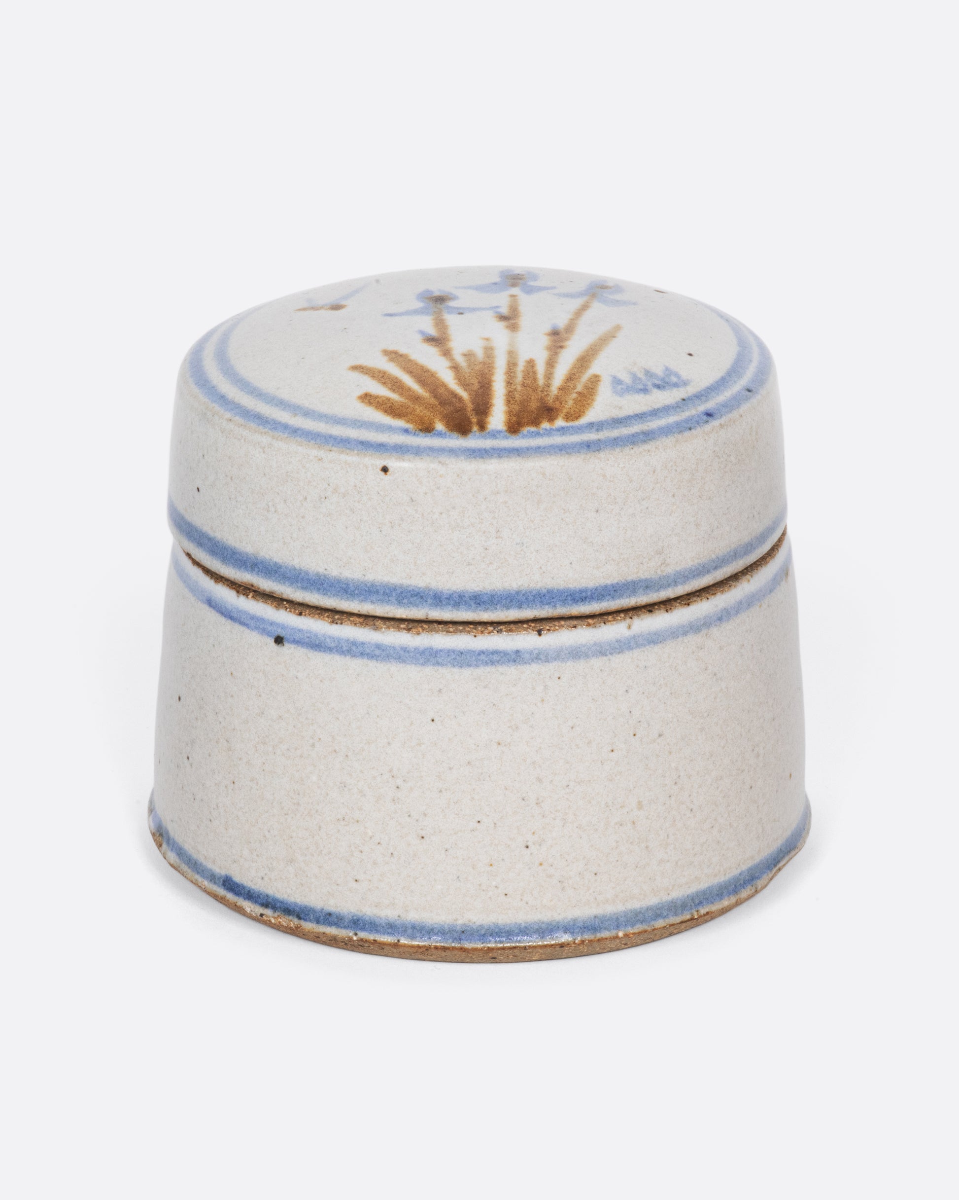 A sweet ceramic round box with blue irises hand painted on the lid.
