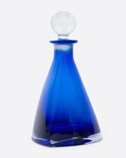 Vintage blue glass decanter, front view with the stopper in