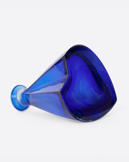 Vintage blue glass decanter laid on its side showing the base