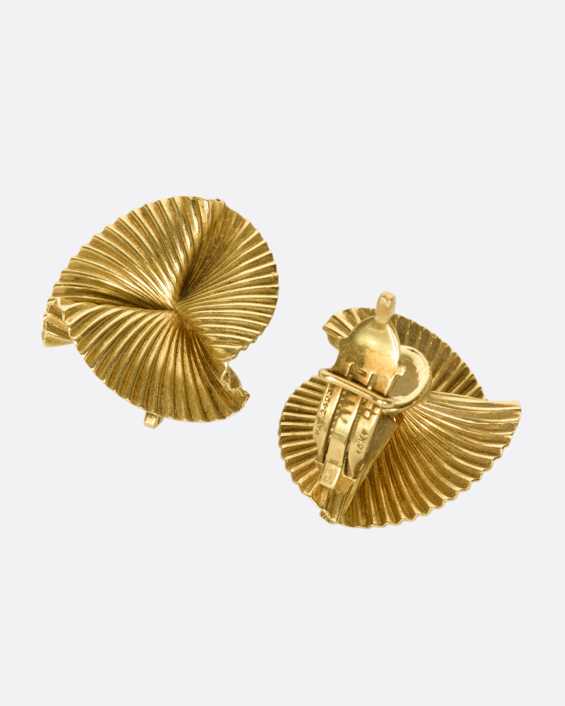 Vintage clip-on 14k gold round fan earrings. These are especially beautiful as the ribbed lines grab light, fanning it across your lobes.