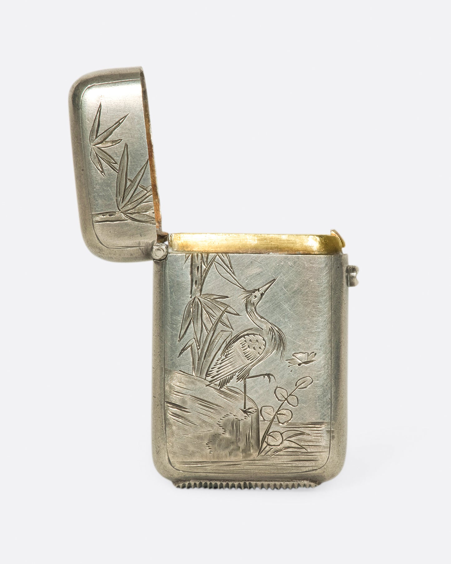 A pocket sized stash box with a hand etched crane, dating back to 1879 Birmingham, England.