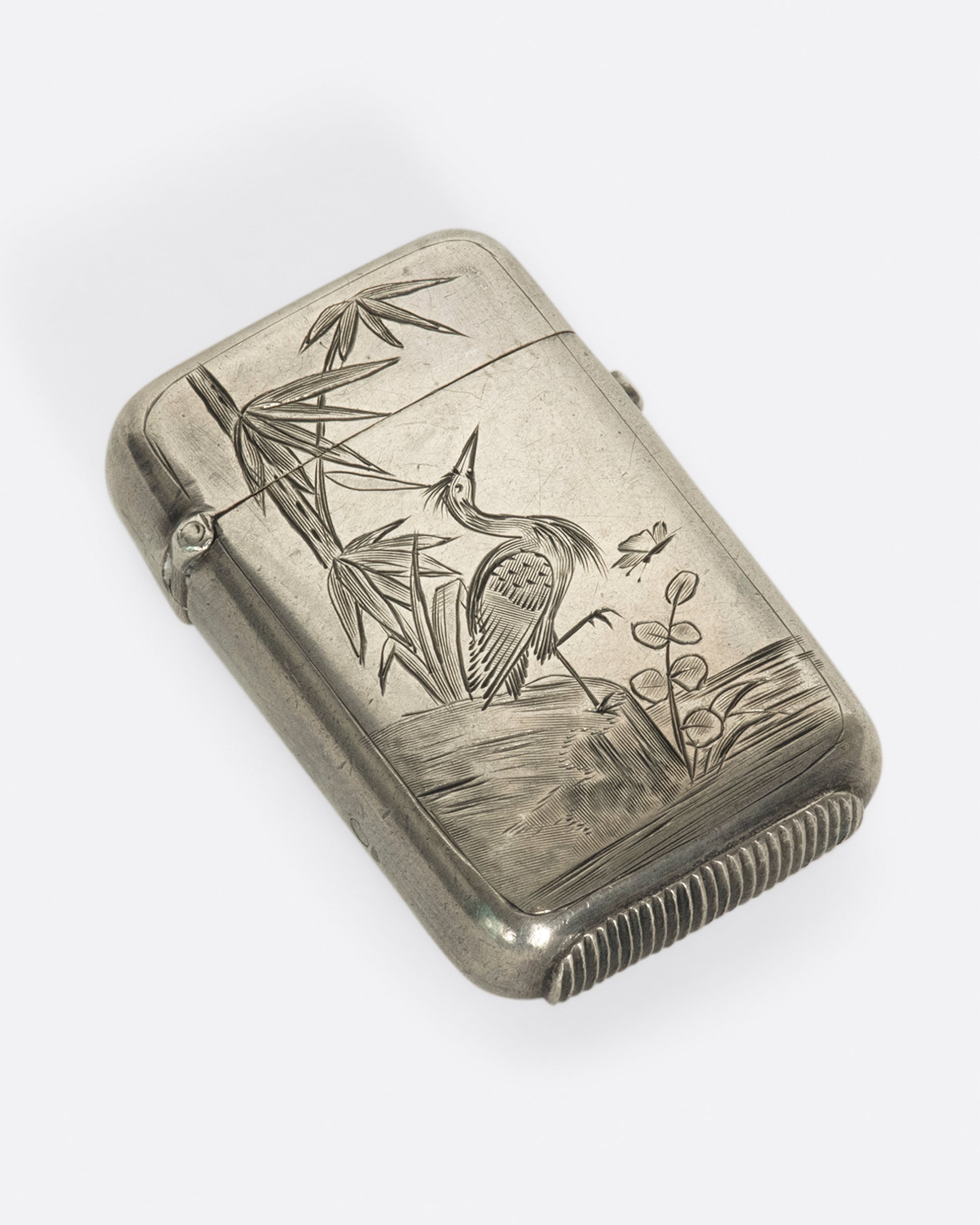 A pocket sized stash box with a hand etched crane, dating back to 1879 Birmingham, England.