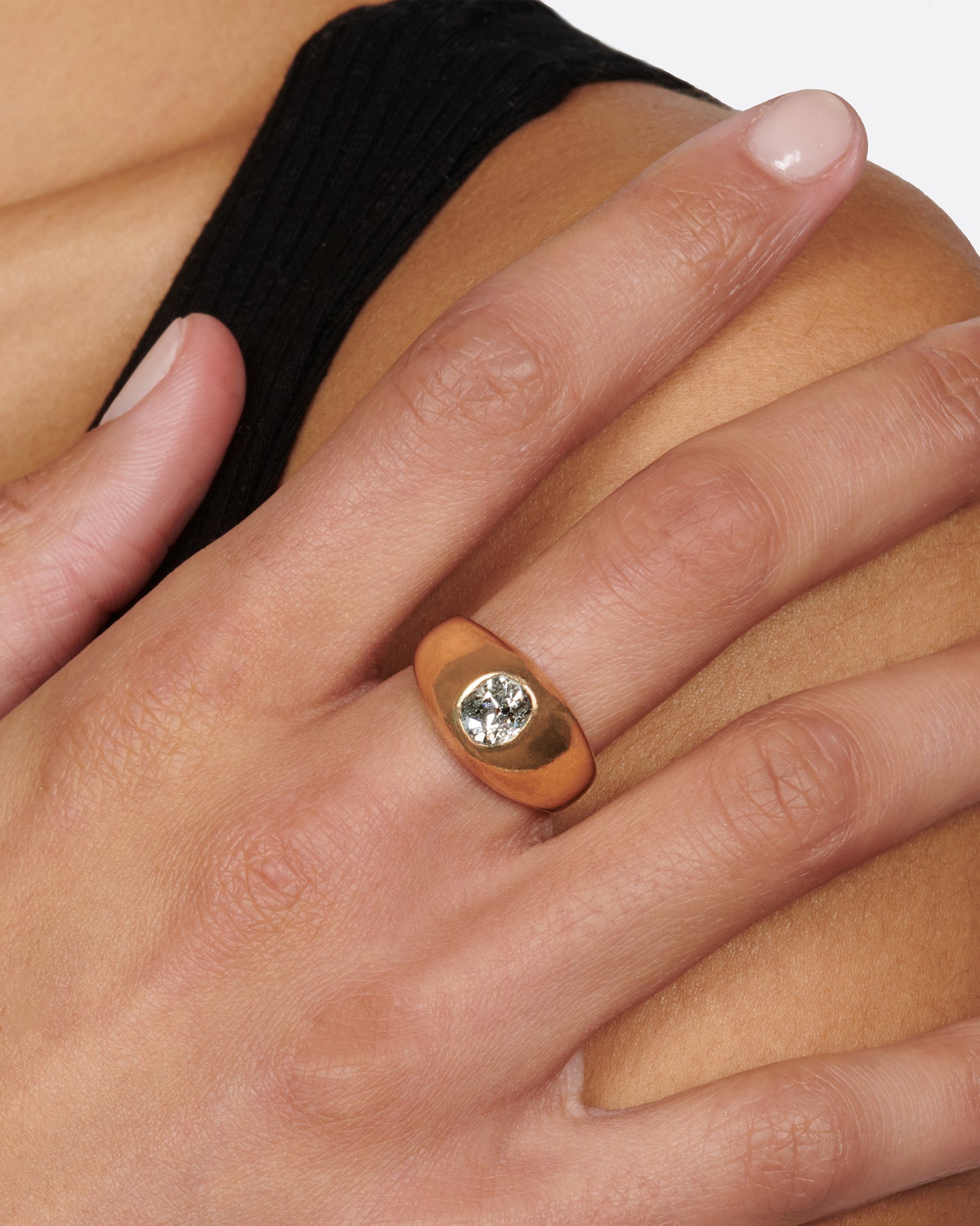 A classic, vintage dome ring with an oval old mine cut diamond sunk into the top of it.