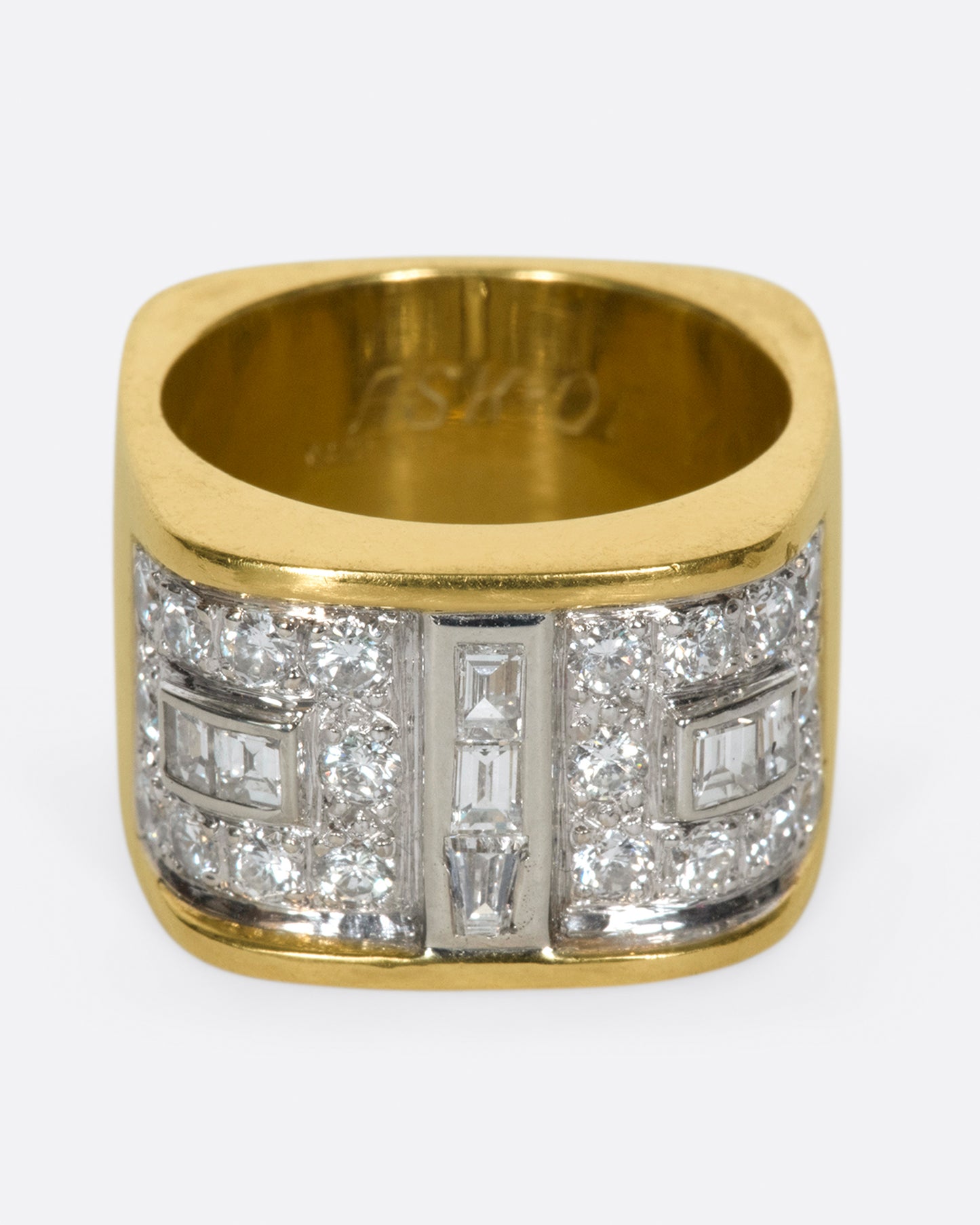 A square gold ring with a mosaic of baguette and round diamonds.