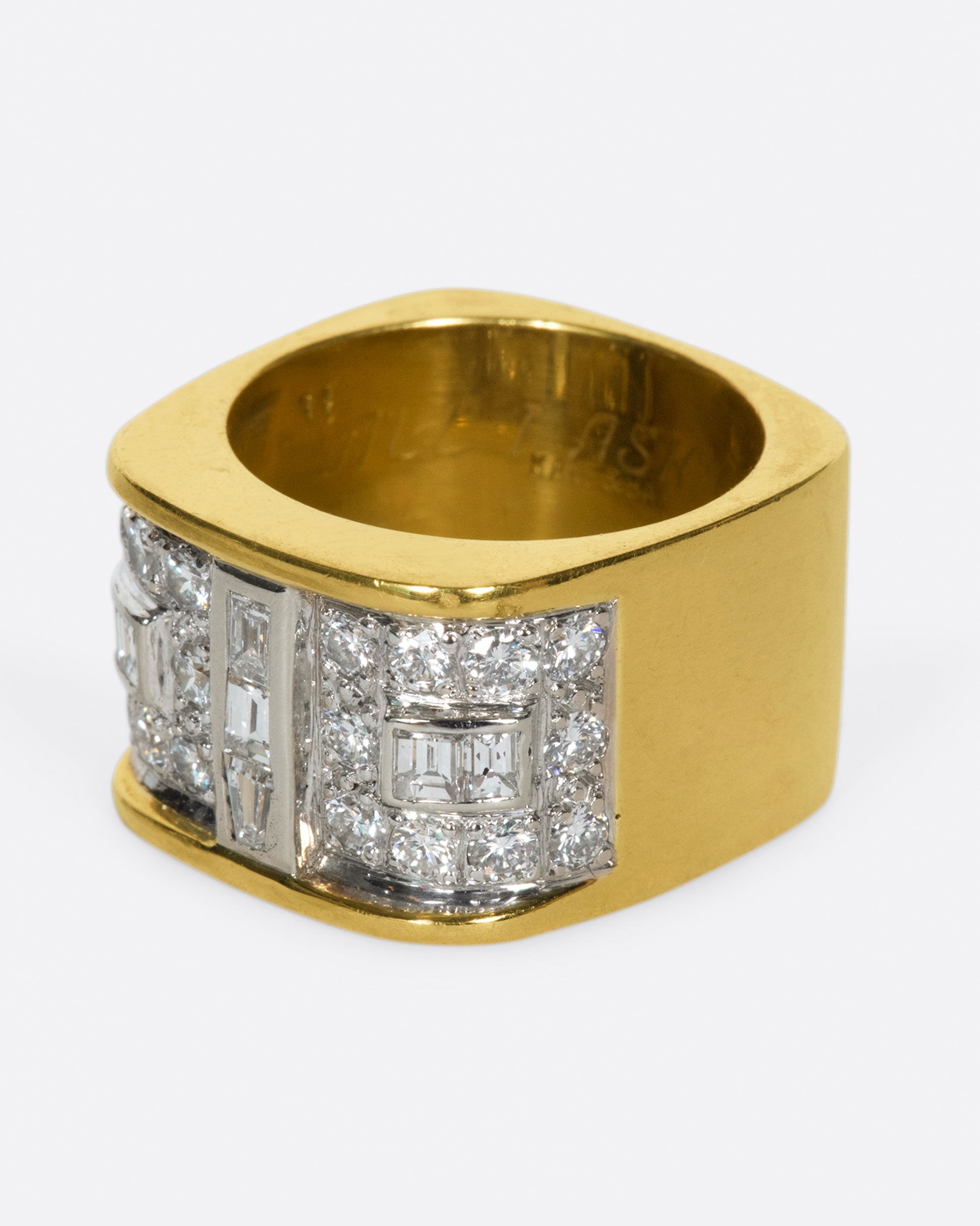 A square gold ring with a mosaic of baguette and round diamonds.