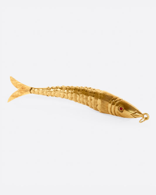 This vintage 14k gold fish has an articulated body that moves when you shake it and glowing ruby eyes