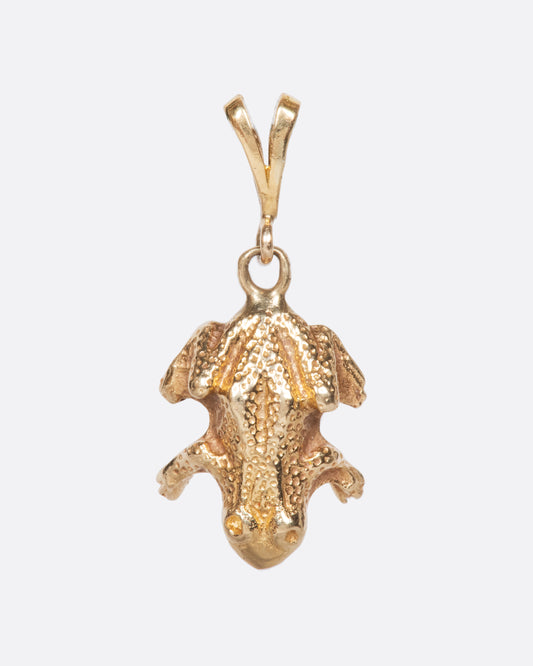 A yellow gold vintage frog charm with incredible detail and texture.