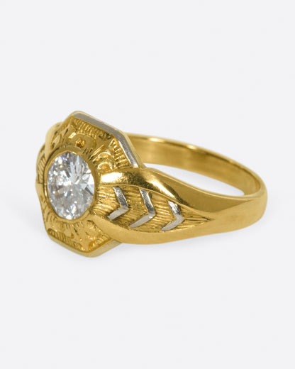 Vintage gold and platinum diamond ring, side view with the diamond facing left and the chevron detail on the shoulder