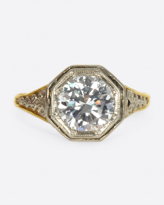 Mixed metals, intricate setting, large diamond; the ultimate vintage engagement ring.