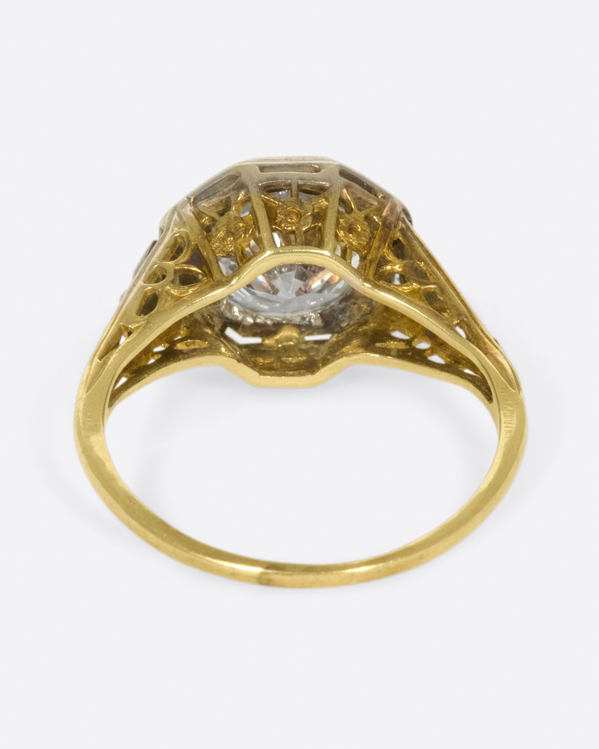 Mixed metals, intricate setting, large diamond; the ultimate vintage engagement ring.