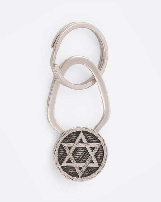 A Star of David key chain with crosshatching texture that offers both a key ring and a hook closure.