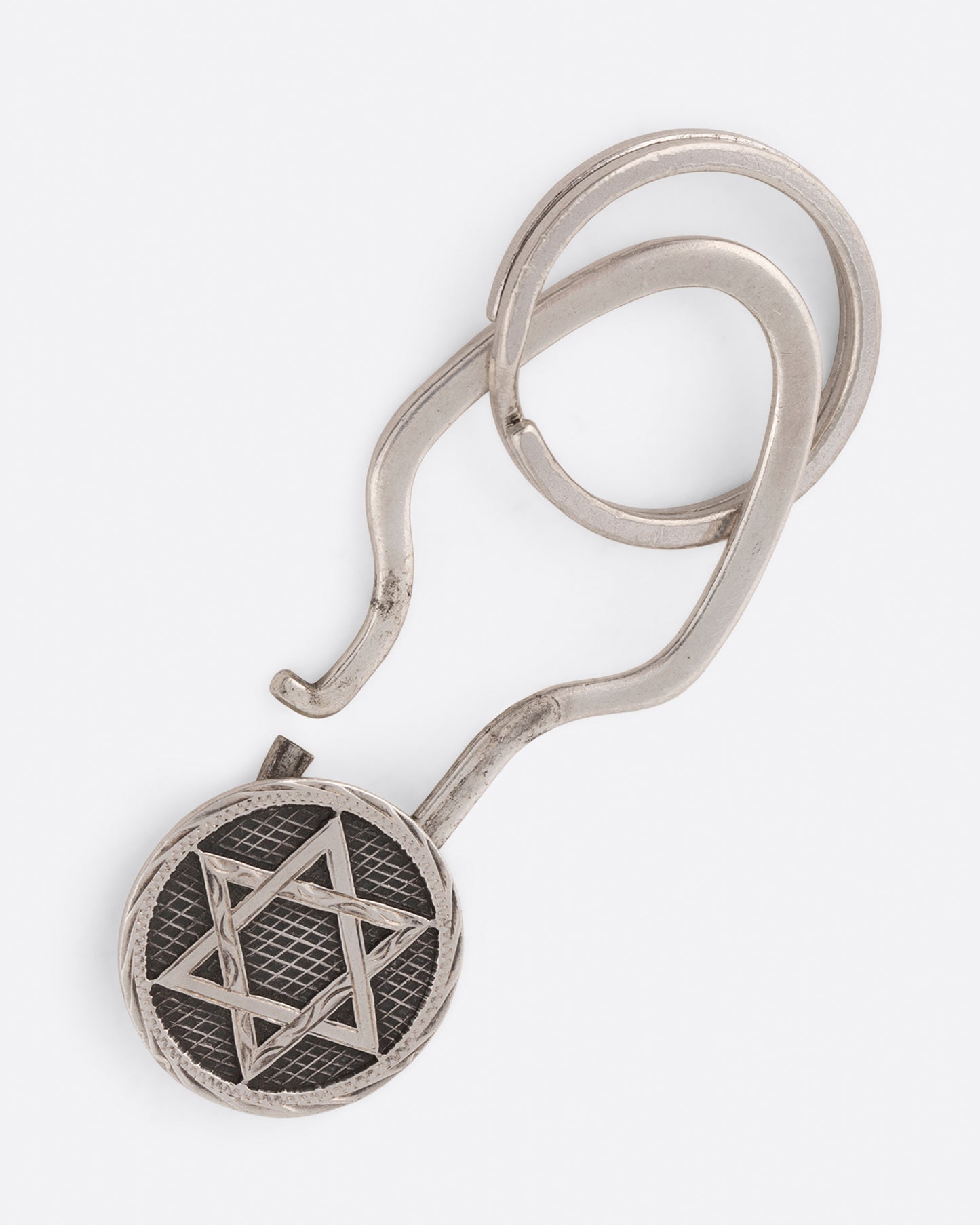 A Star of David key chain with crosshatching texture that offers both a key ring and a hook closure.
