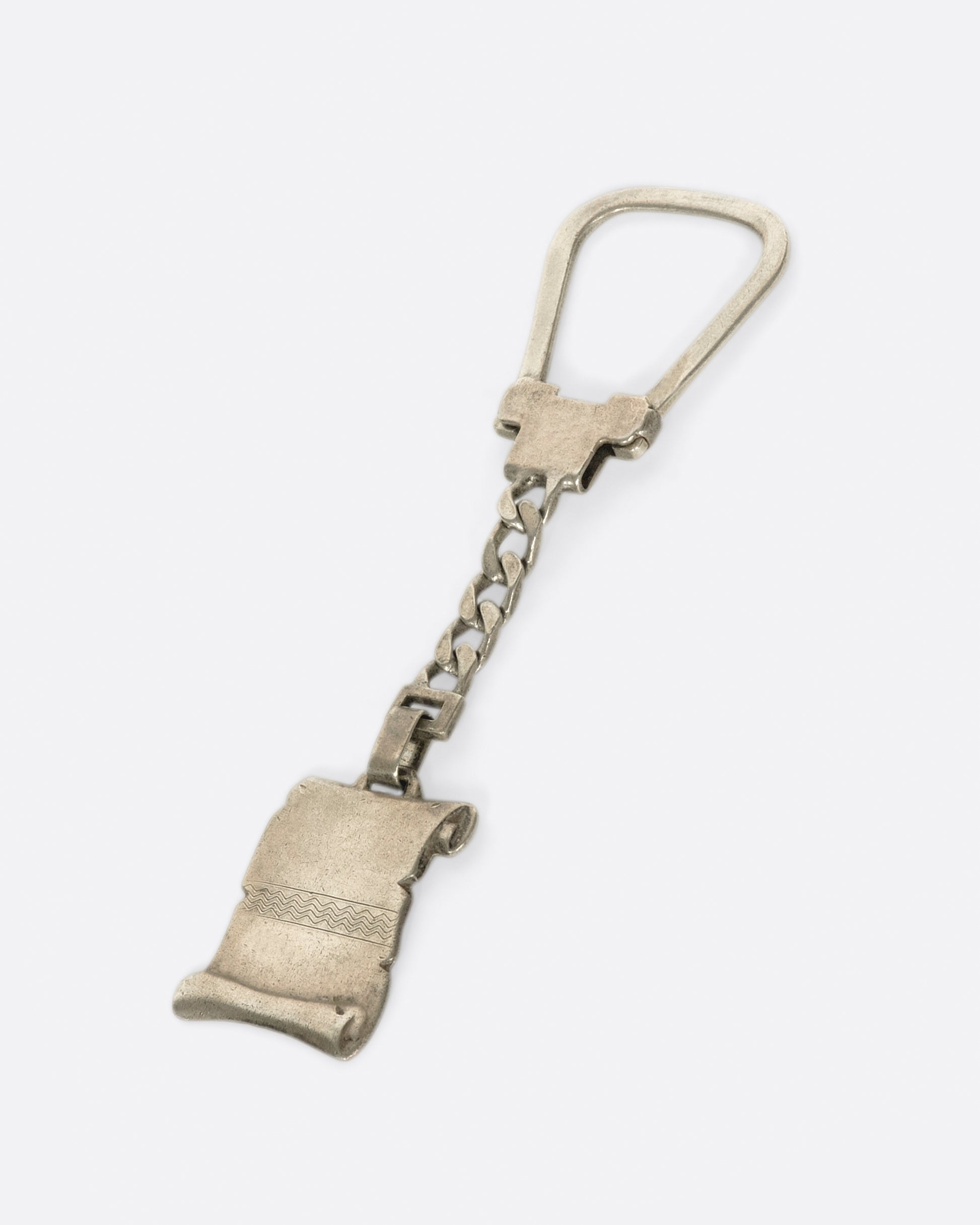 A vintage sterling silver scroll keychain, with the perfect amount of space for an engraving.