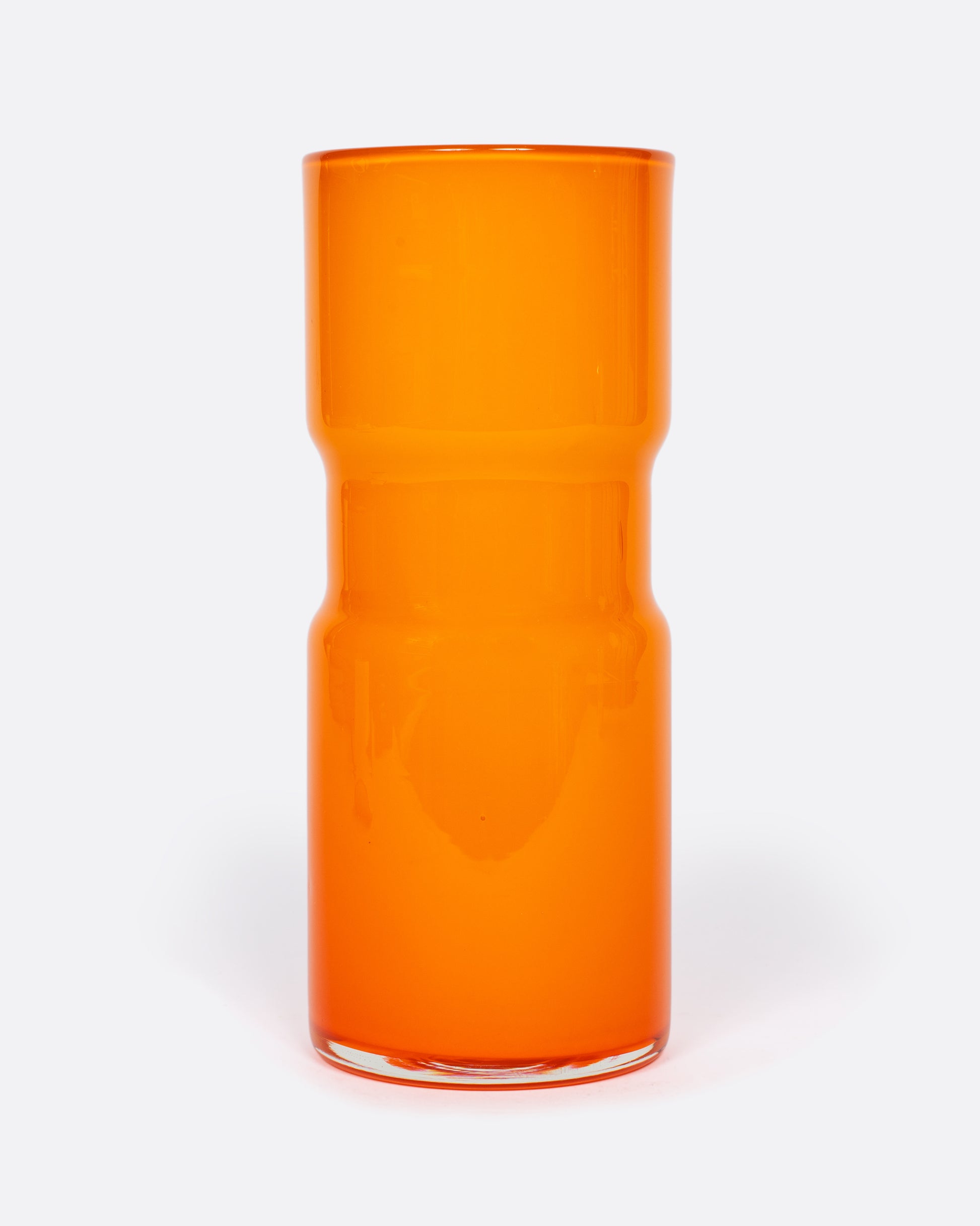 A citrus orange vintage cased glass pitcher made by layering orange glass over over white glass. It's the perfect splash of color for your summer tablescape.