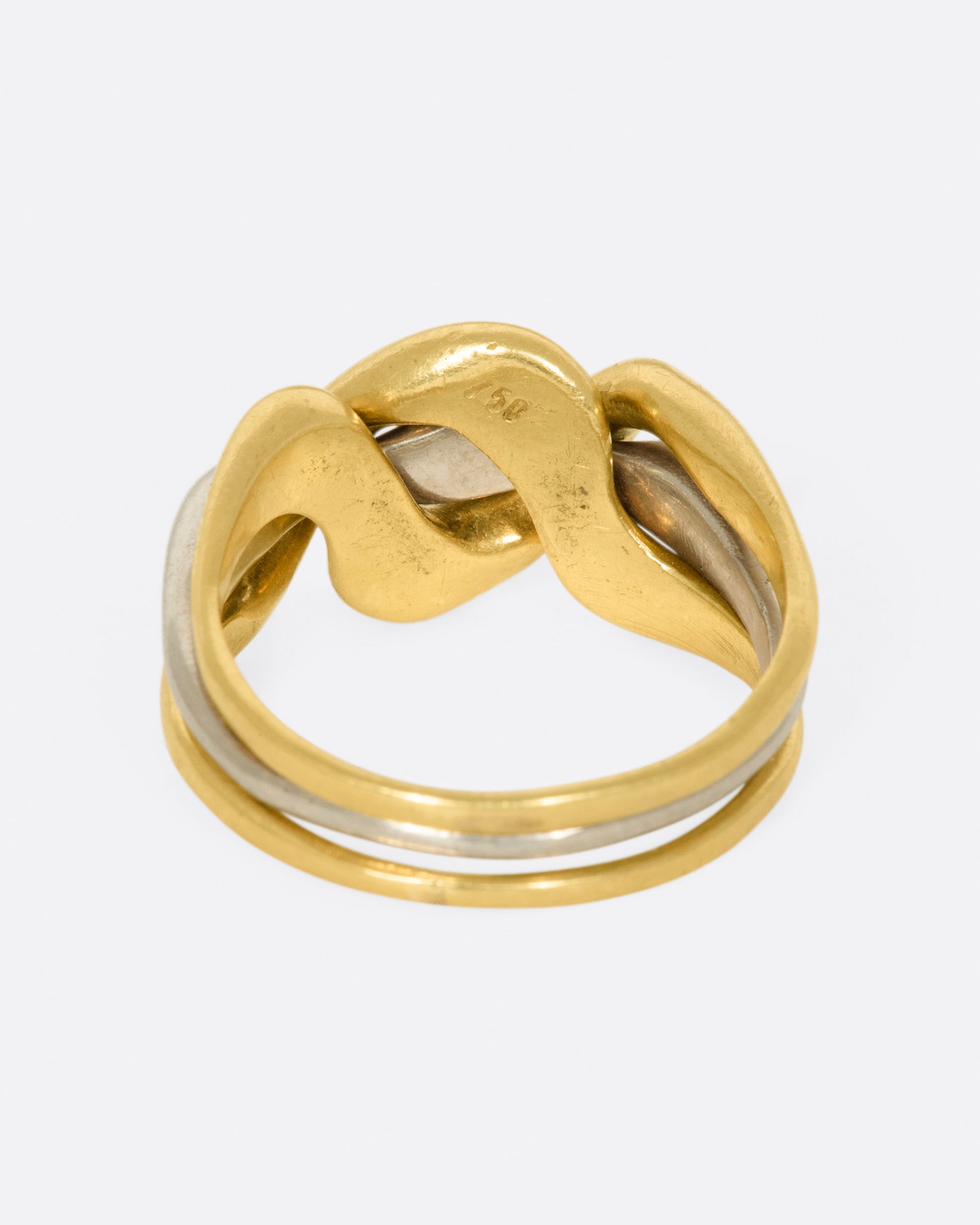 A puffy, yellow and white gold puzzle ring that, no matter how you shake it, will never come unlinked.