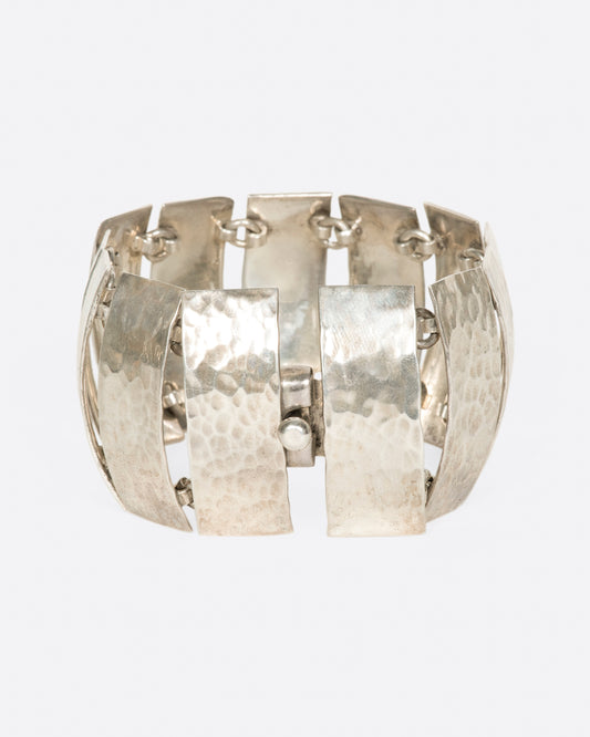 These curved pieces are connected vertically to give the illusion of a cuff bracelet.