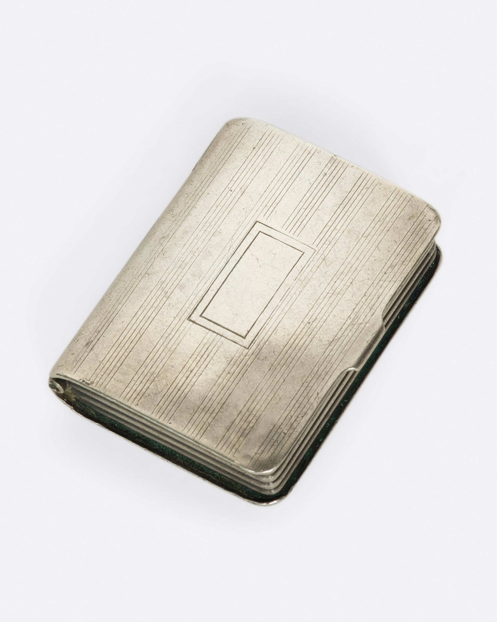 An intriguing sterling silver pill box, crafted to look like a mini book. 