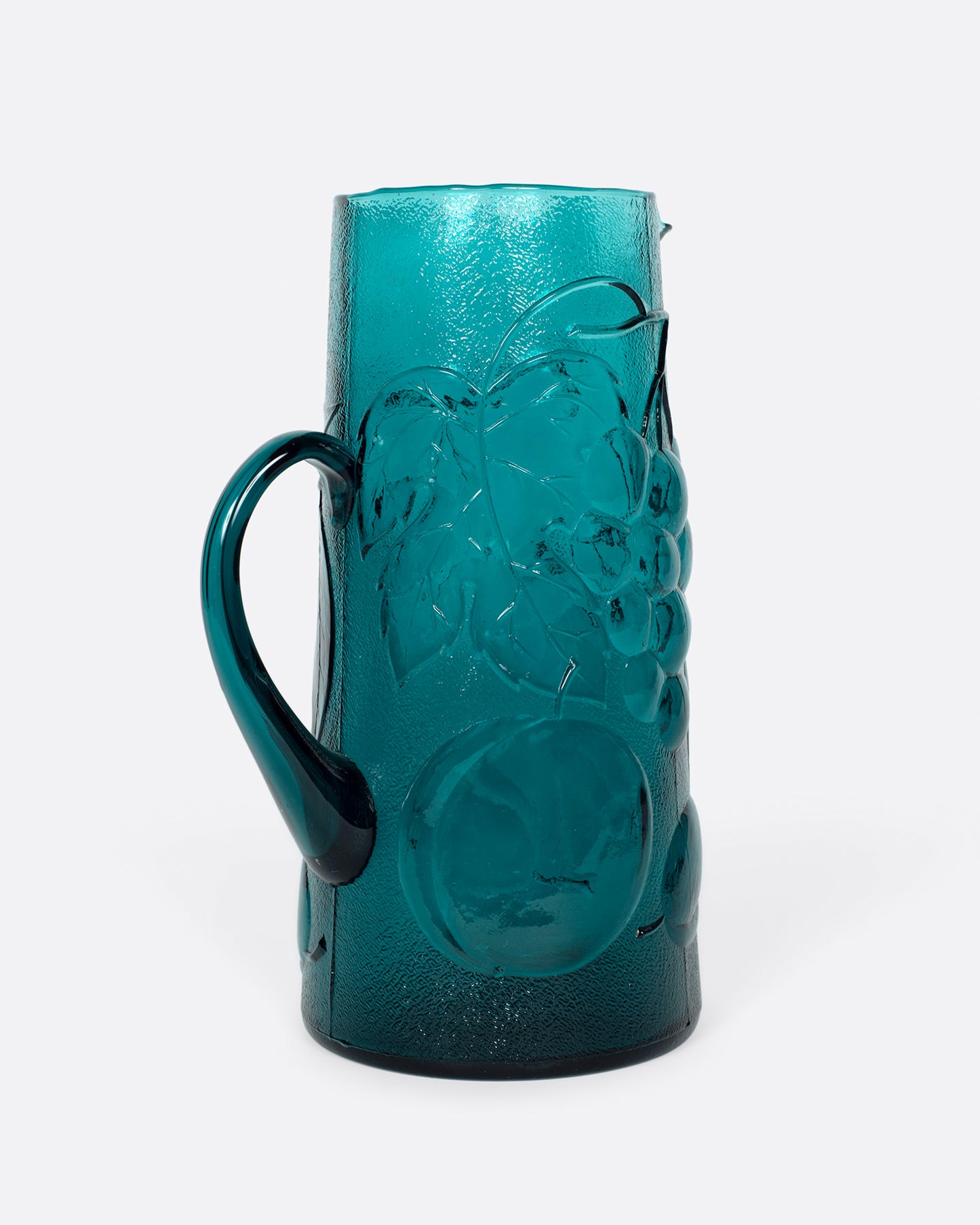 This teal glass set has a subtle fruity texture.