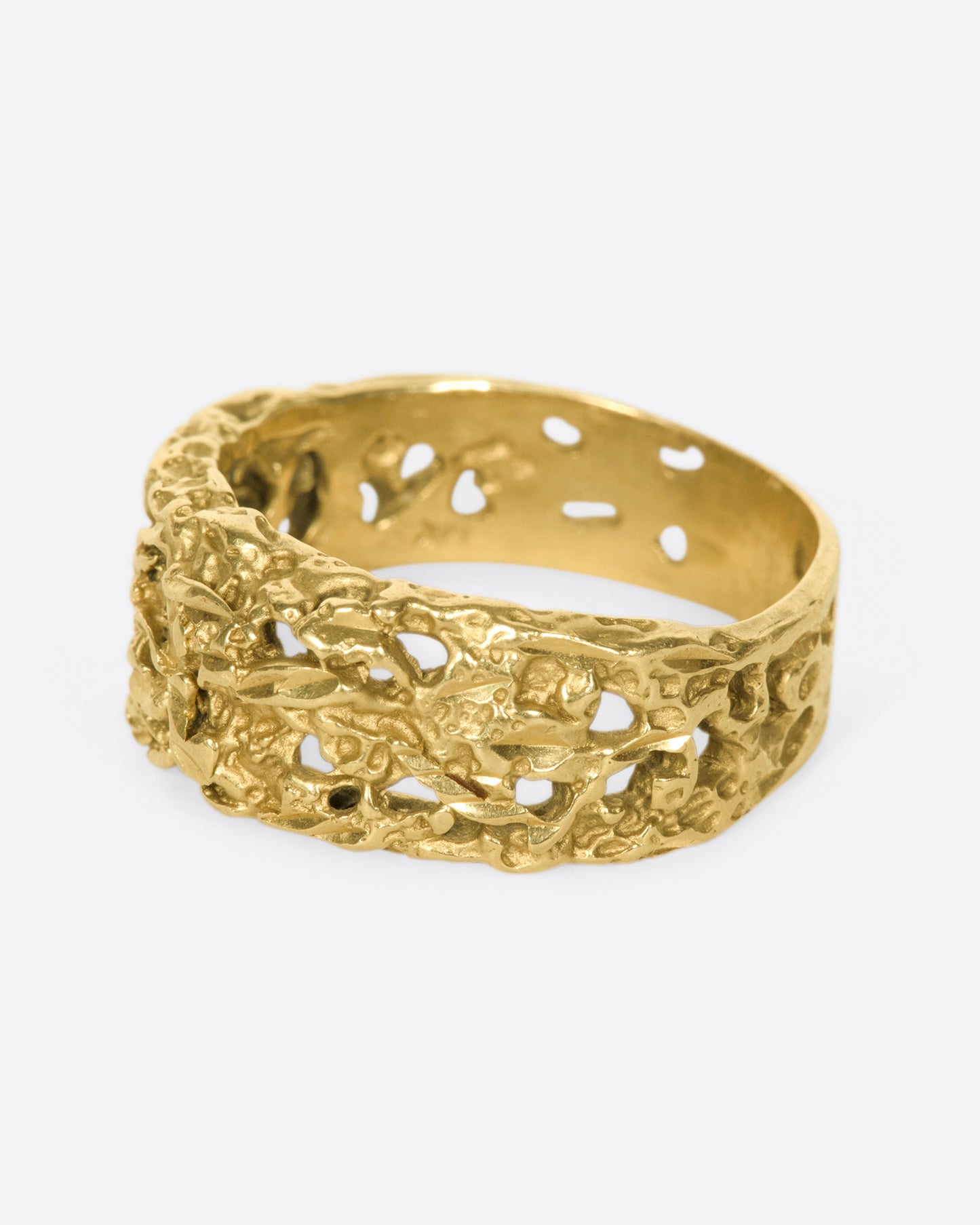 The cutouts on this ring almost look like the gold has eroded away, leaving little windows.