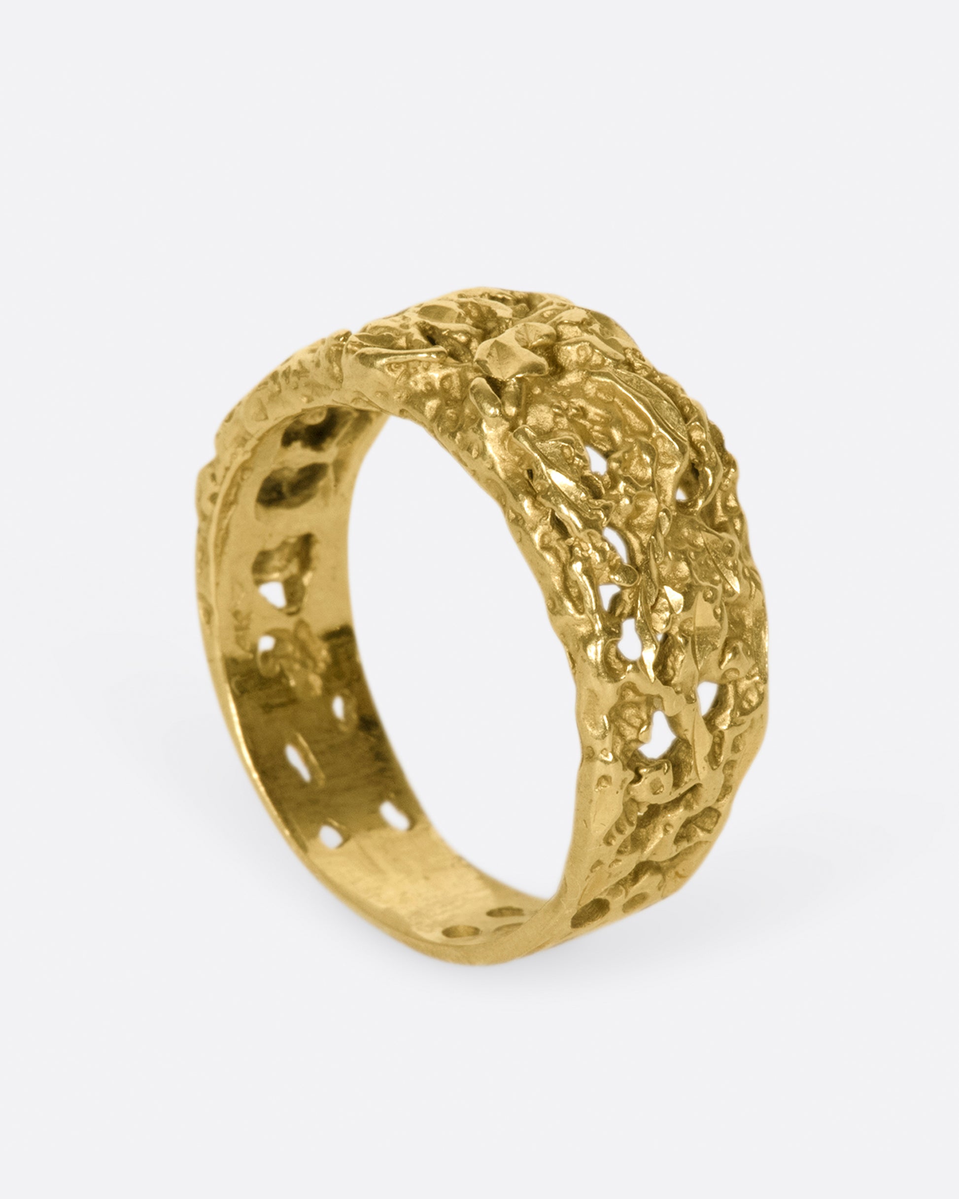 The cutouts on this ring almost look like the gold has eroded away, leaving little windows.