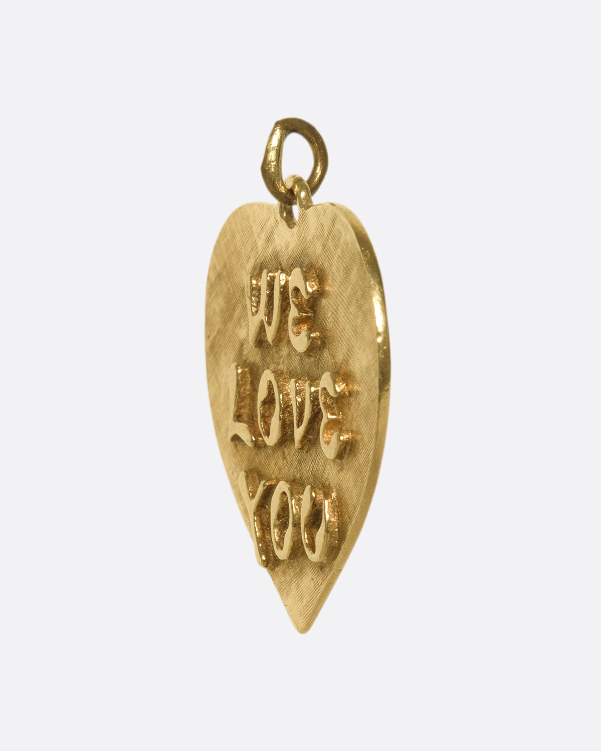 A large, textured heart tag with sweet sentiments on either side.