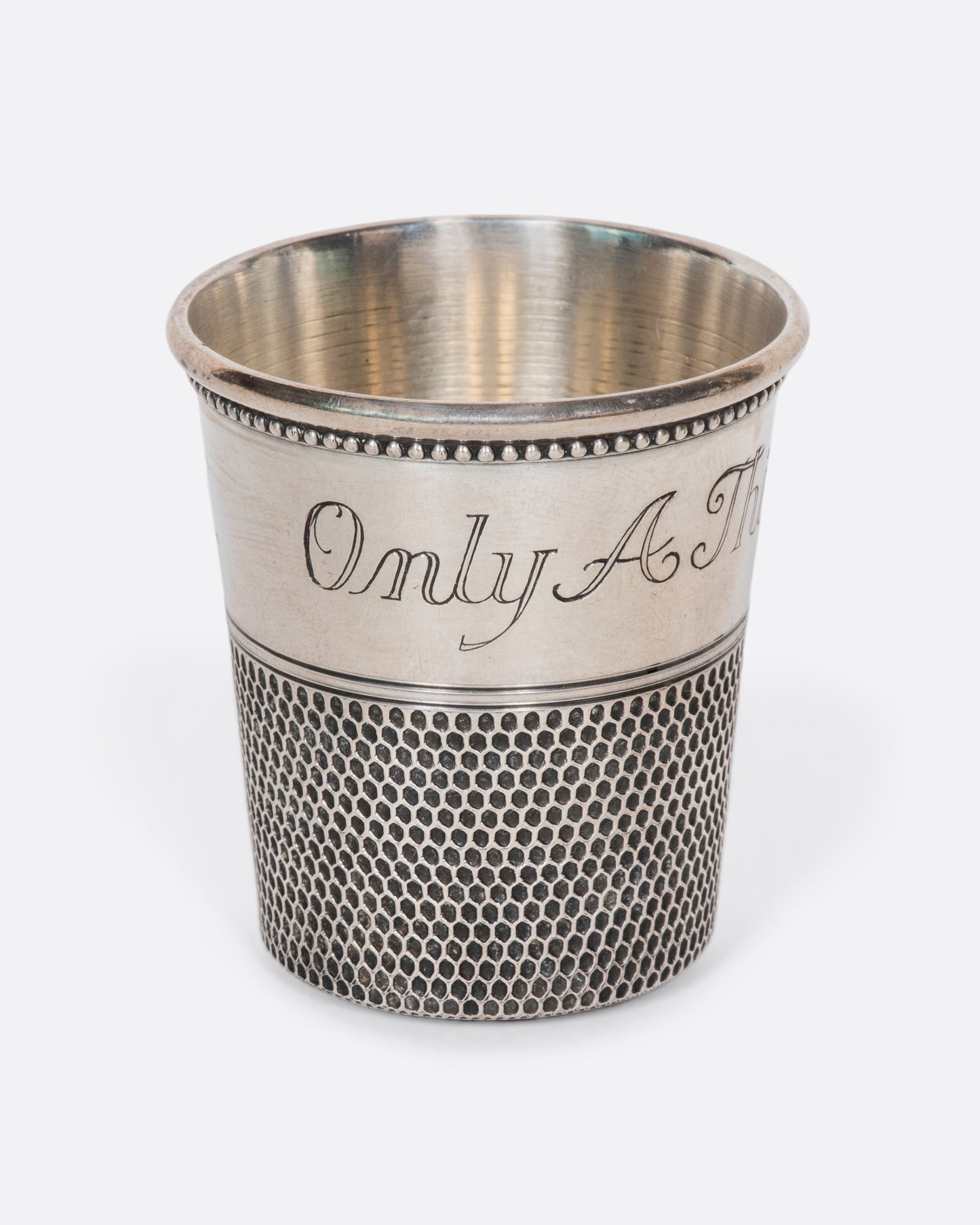 This rare sterling silver vintage shot glass is engraved with "Only a thimble full". A cheeky, yet elegant addition to any bar.