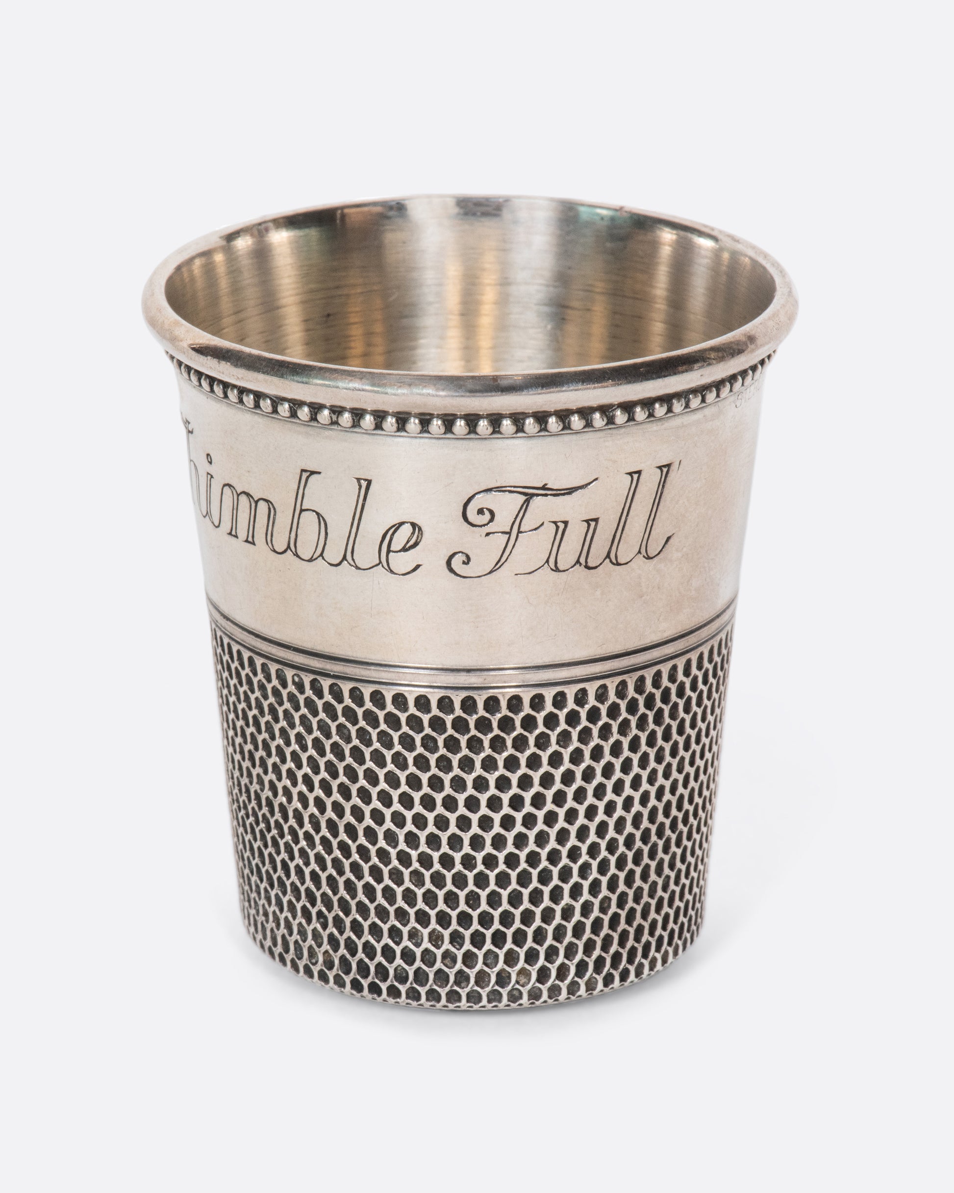 This rare sterling silver vintage shot glass is engraved with "Only a thimble full". A cheeky, yet elegant addition to any bar.