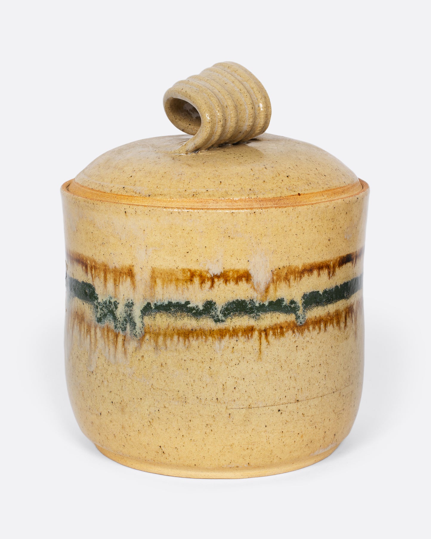 A vintage ceramic speckled jar with blue and brown abstract stripes and a twisted handle. A one-of-a-kind place to store sugar or your favorite dry good.