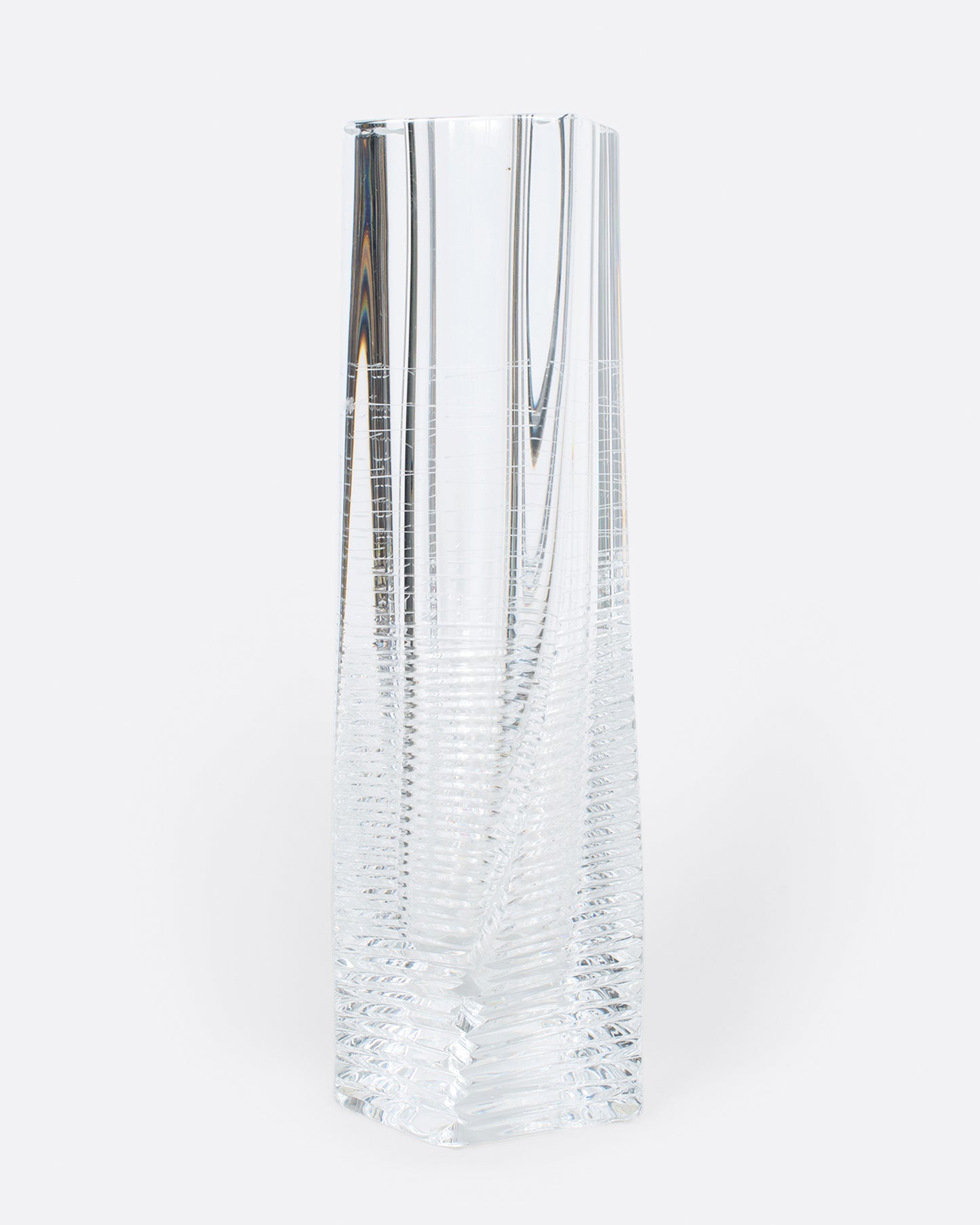 A fantastic, heavy clear glass textured vase. The vase itself is subtly twisted and has glorious rainbows throughout. A magical piece to put in a sunny spot and a Lori favorite!