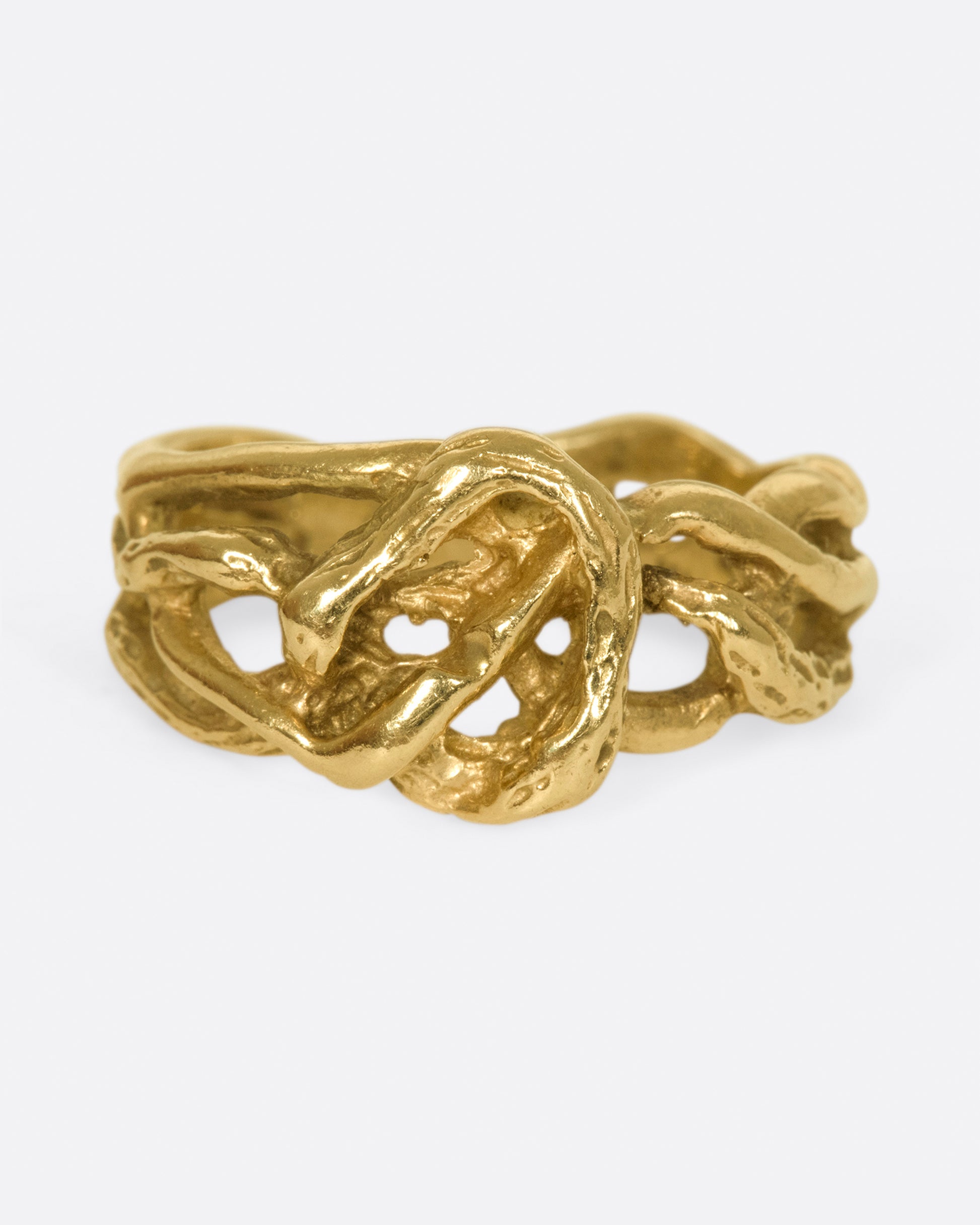 A vintage gold ring in the shape of interwoven vines.