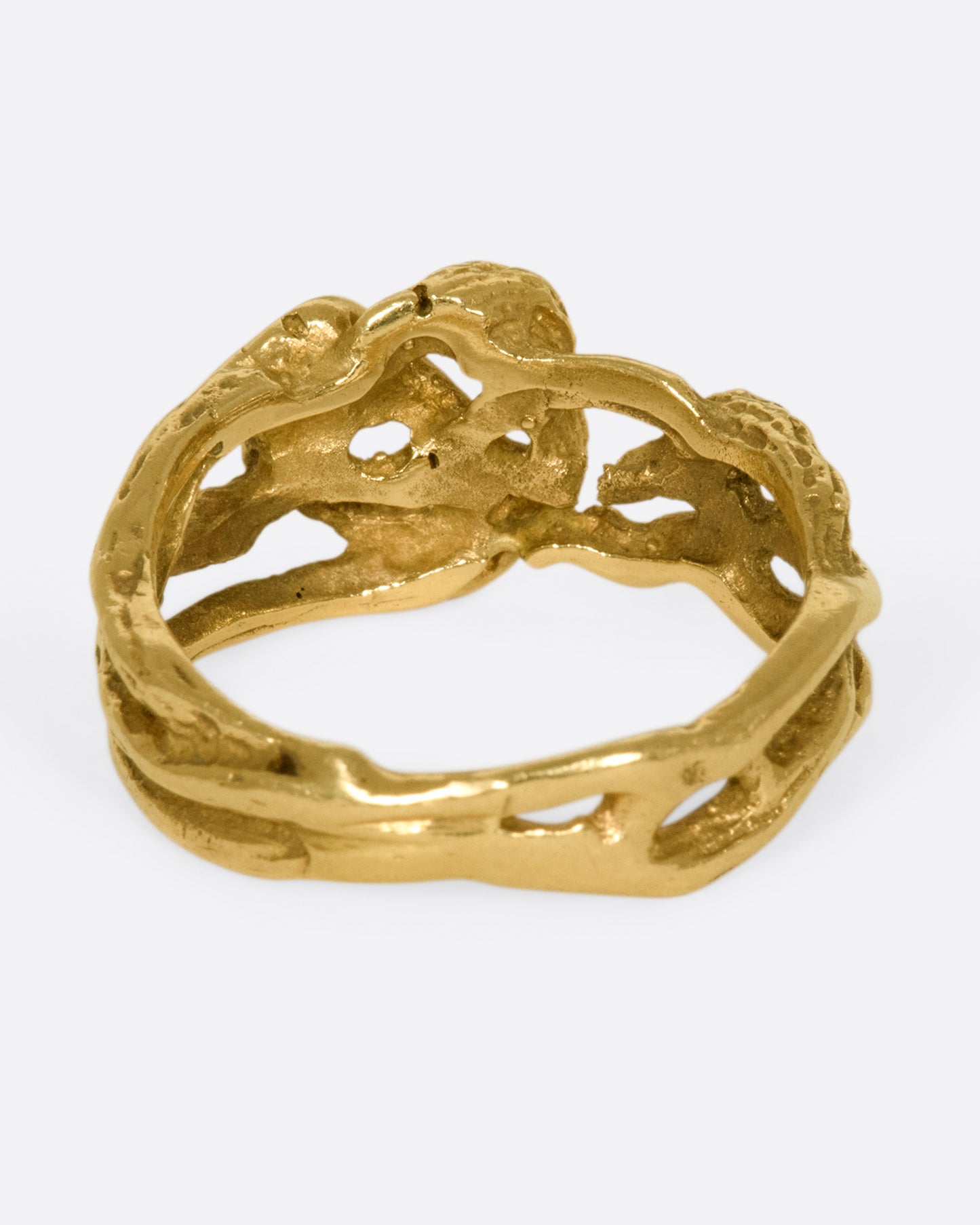 A vintage gold ring in the shape of interwoven vines.