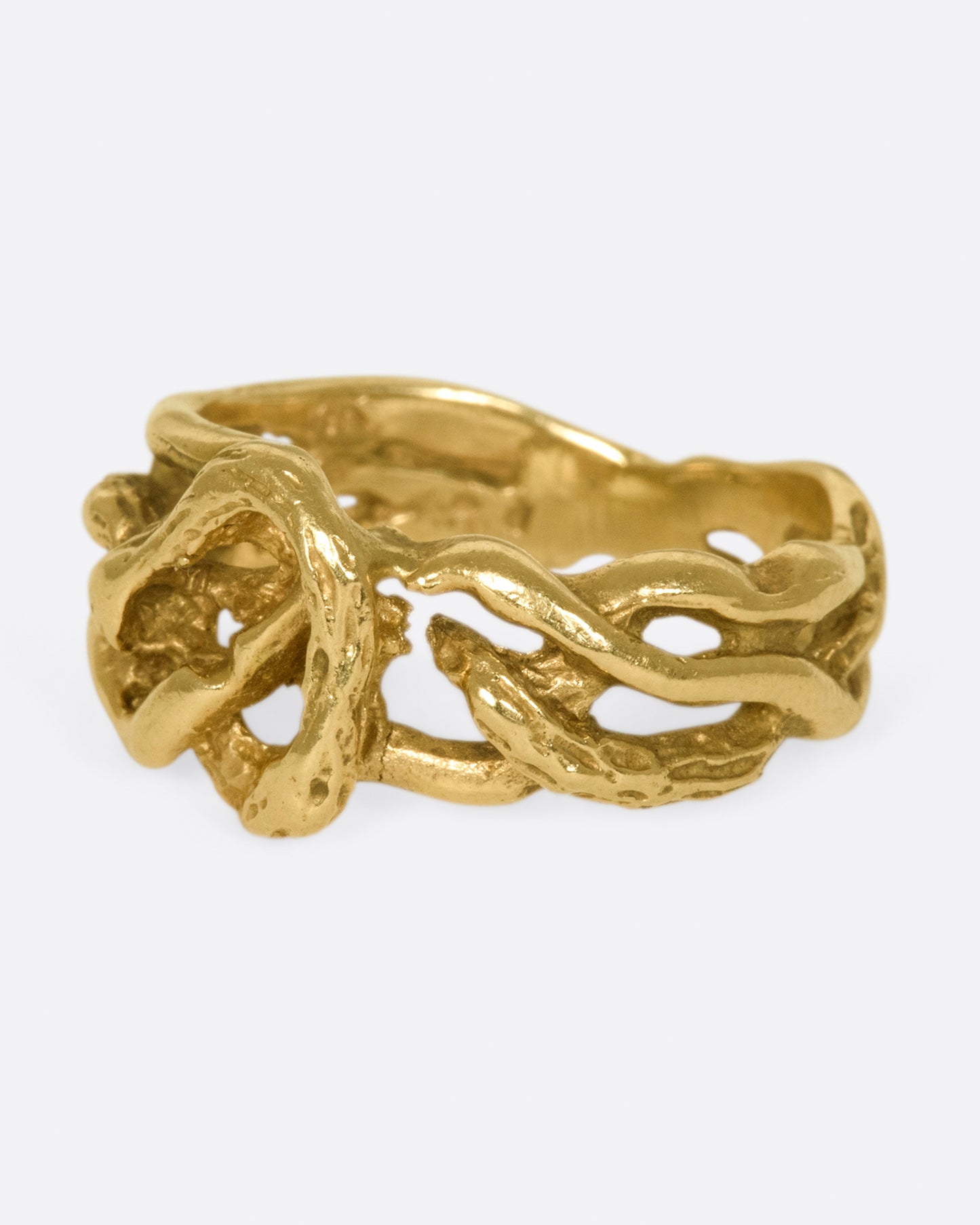 A vintage gold ring in the shape of interwoven vines.