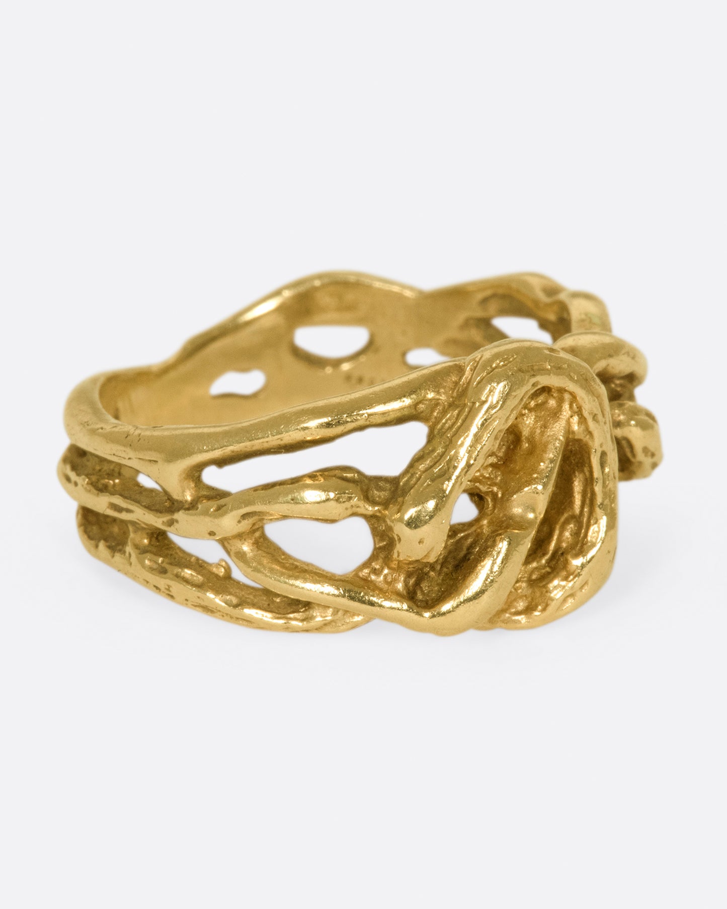 A vintage gold ring in the shape of interwoven vines.