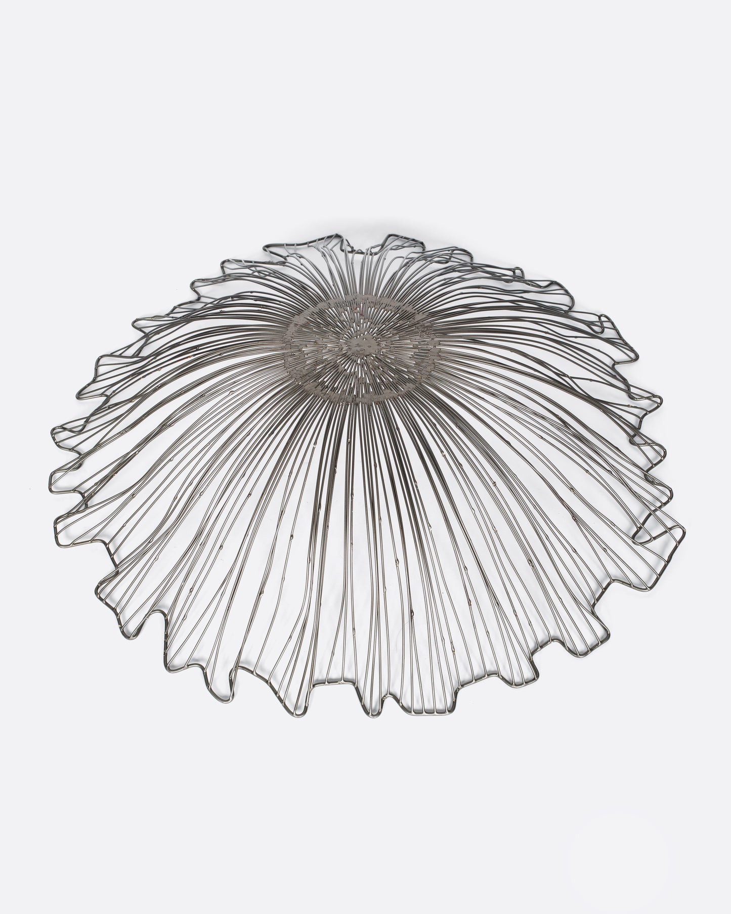 A wide, rippled wire bowl that's the perfect centerpiece for a kitchen island or dinner table.