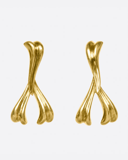 These earrings curve slightly to mirror one another when worn, framing the face.