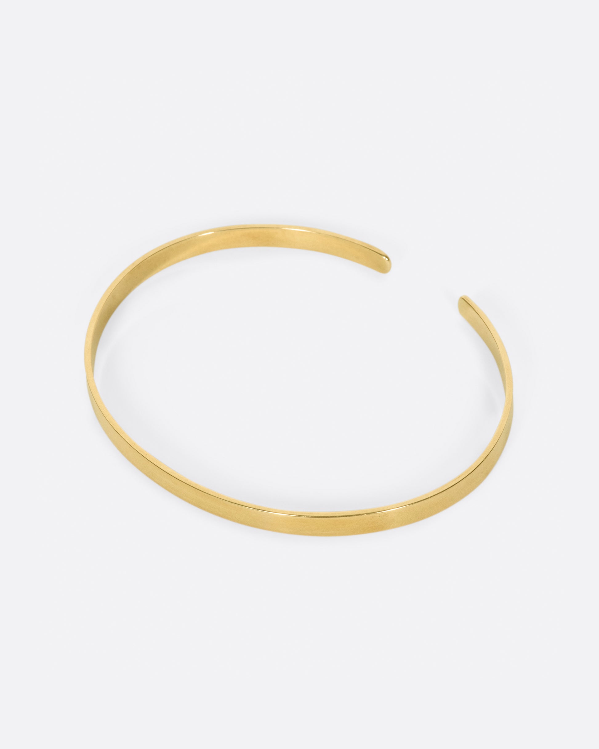 A flat ribbon of gold that looks like a bangle if you wear it face down, but still has all of the flexibility of a cuff.