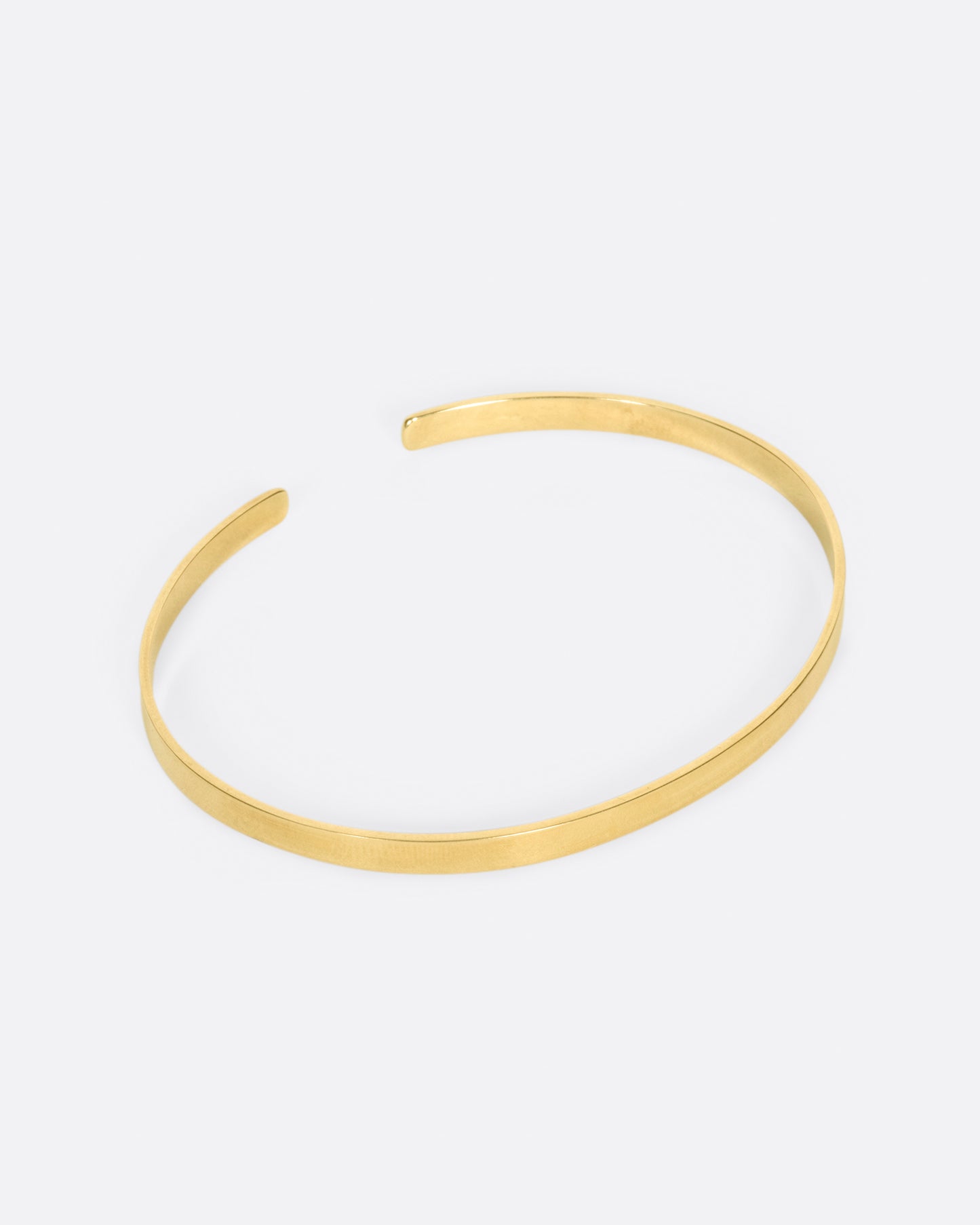 A flat ribbon of gold that looks like a bangle if you wear it face down, but still has all of the flexibility of a cuff.