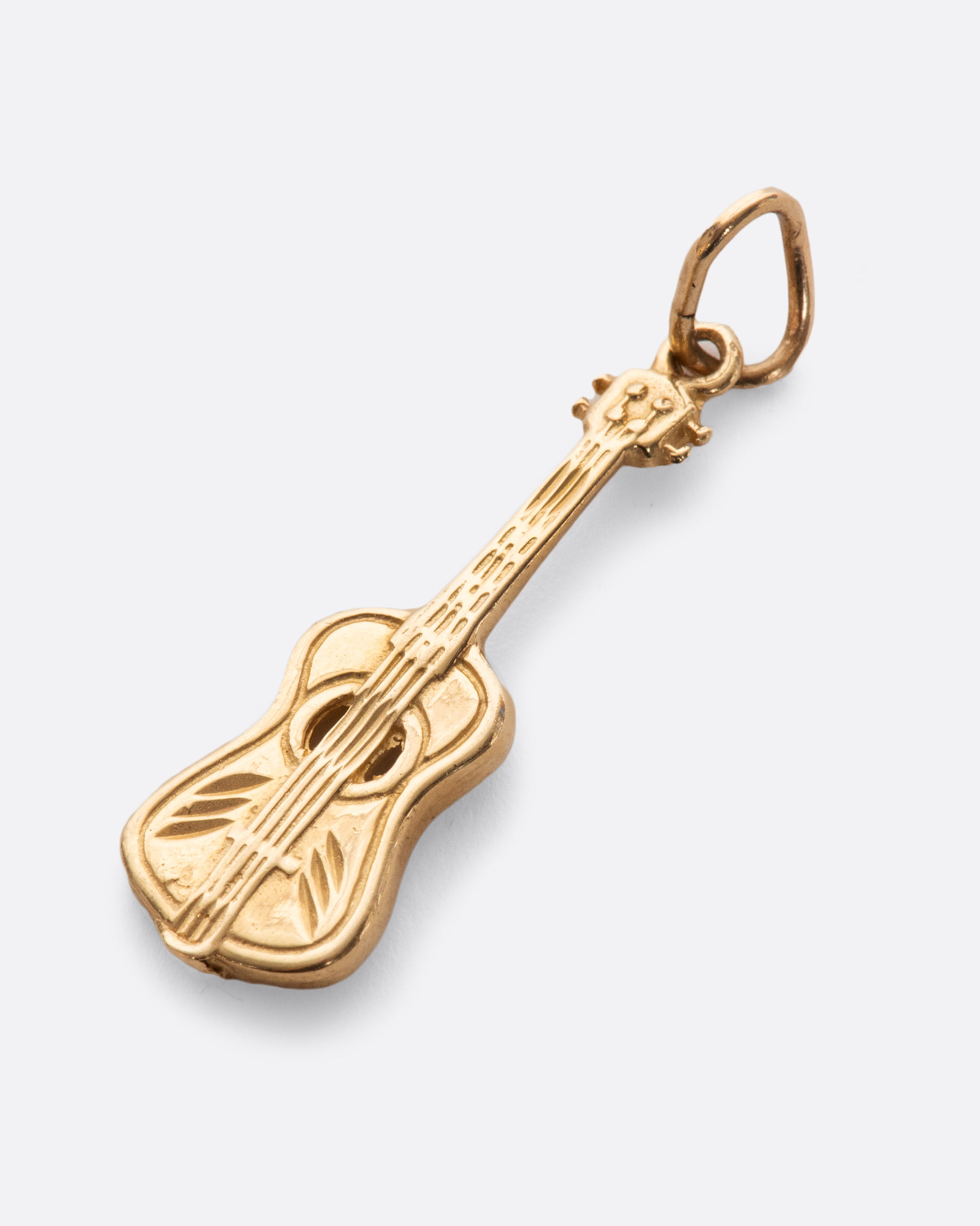 We love the incredible detail in this vintage yellow gold guitar charm, complete with a hollowed out sound hole