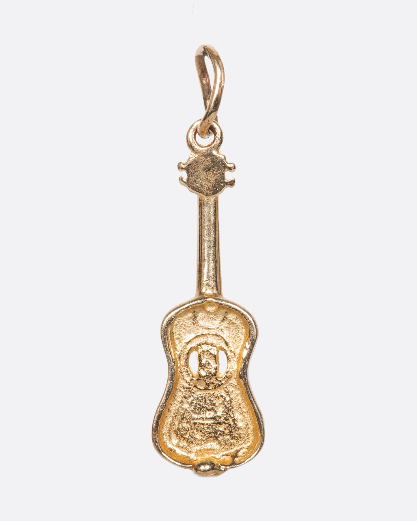 We love the incredible detail in this vintage yellow gold guitar charm, complete with a hollowed out sound hole